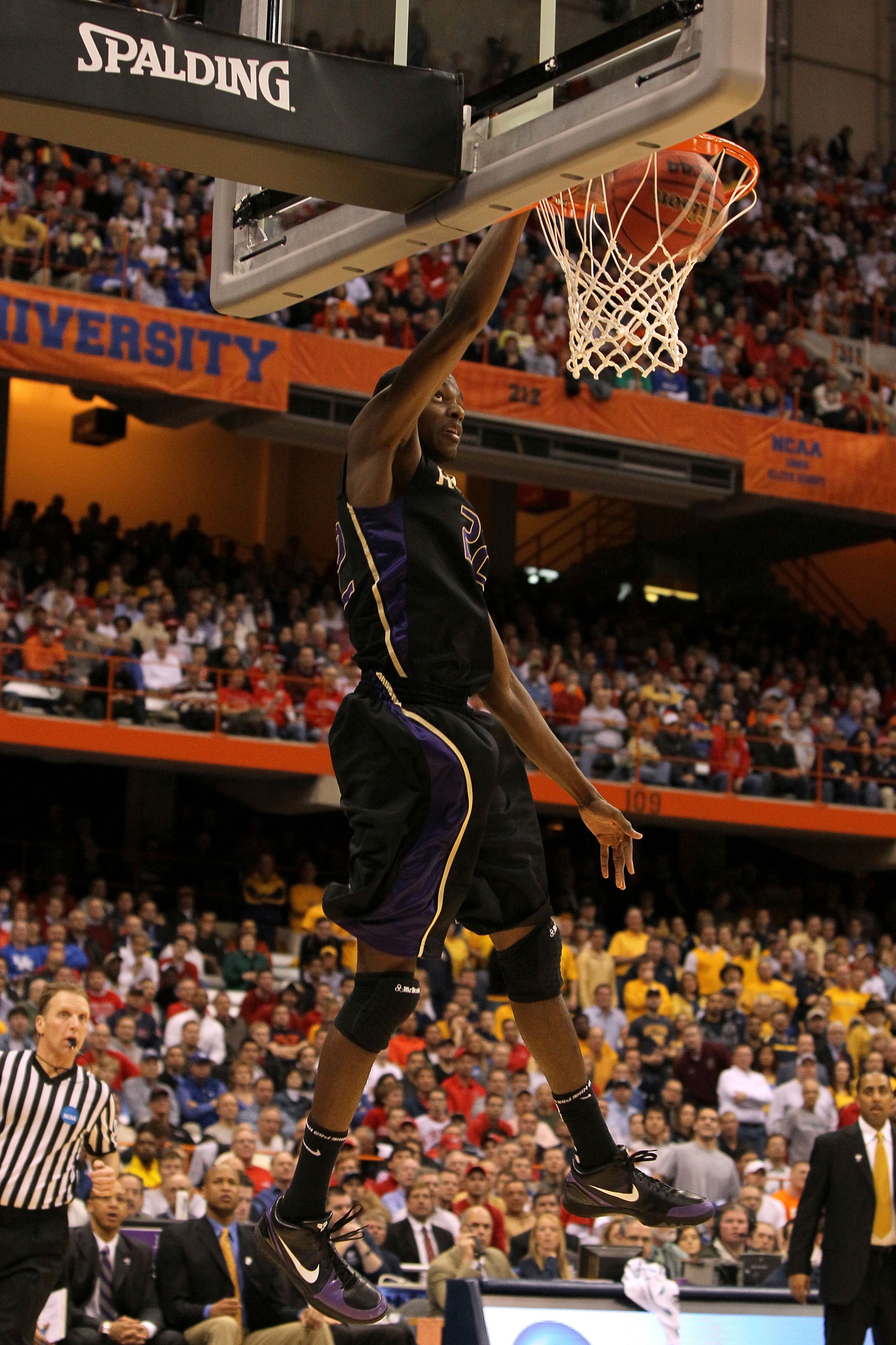 SYRACUSE, NY - MARCH 25: Justin Holiday #22 of the Washington Huskies dunks against the West Virginia Mountaineers during the east regional semifinal of the 2010 NCAA men's basketball tournament at the Carrier Dome on March 25, 2010 in Syracuse, New York