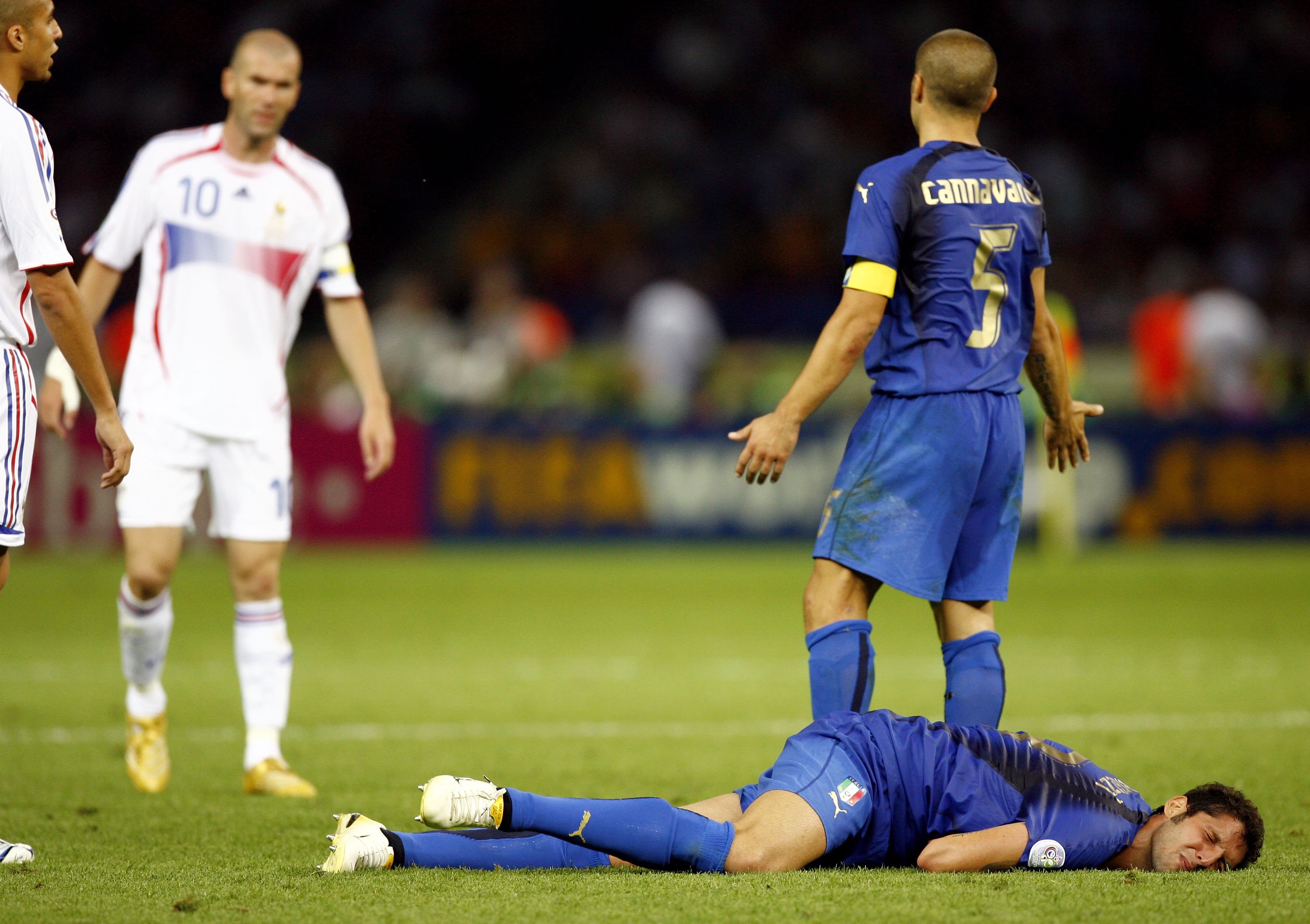 BERLIN - JULY 09:  Fabio Cannavaro (R) of Italy gestures towards Zinedine Zidane #10 (L) of France, whilst Marco Materazzi of Italy lies injured, after being headbutted  in the chest by Zinedine Zidane of France during the FIFA World Cup Germany 2006 Fina
