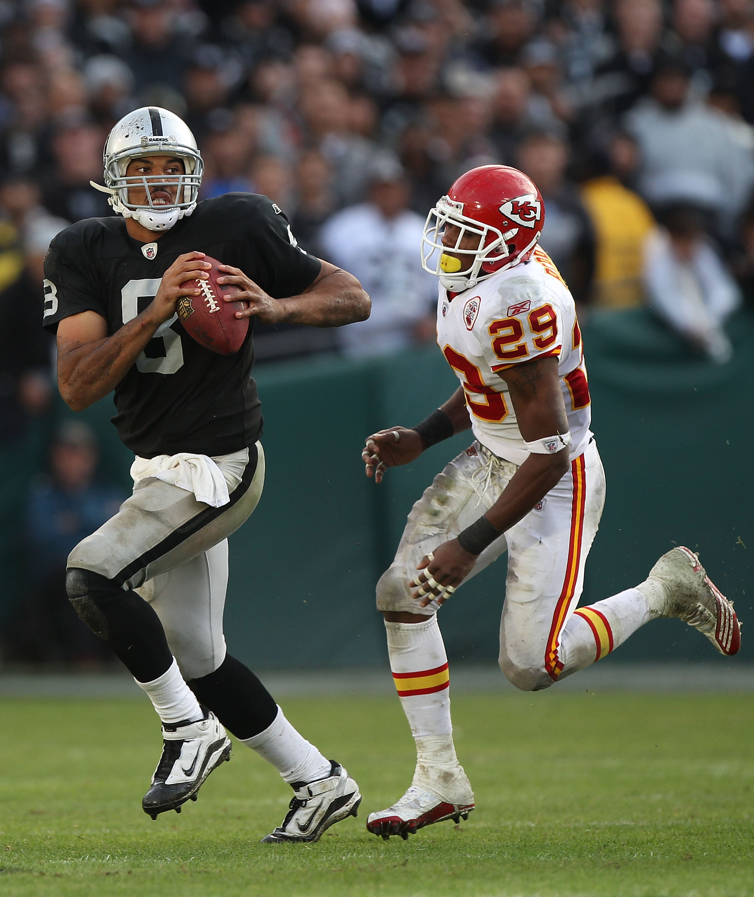 OAKLAND, CA - NOVEMBER 07:  Jason Campbell #8 of the Oakland Raiders runs against Eric Barry #29 of the Kansas City Chiefs during an NFL game at Oakland-Alameda County Coliseum on November 7, 2010 in Oakland, California.  (Photo by Jed Jacobsohn/Getty Ima