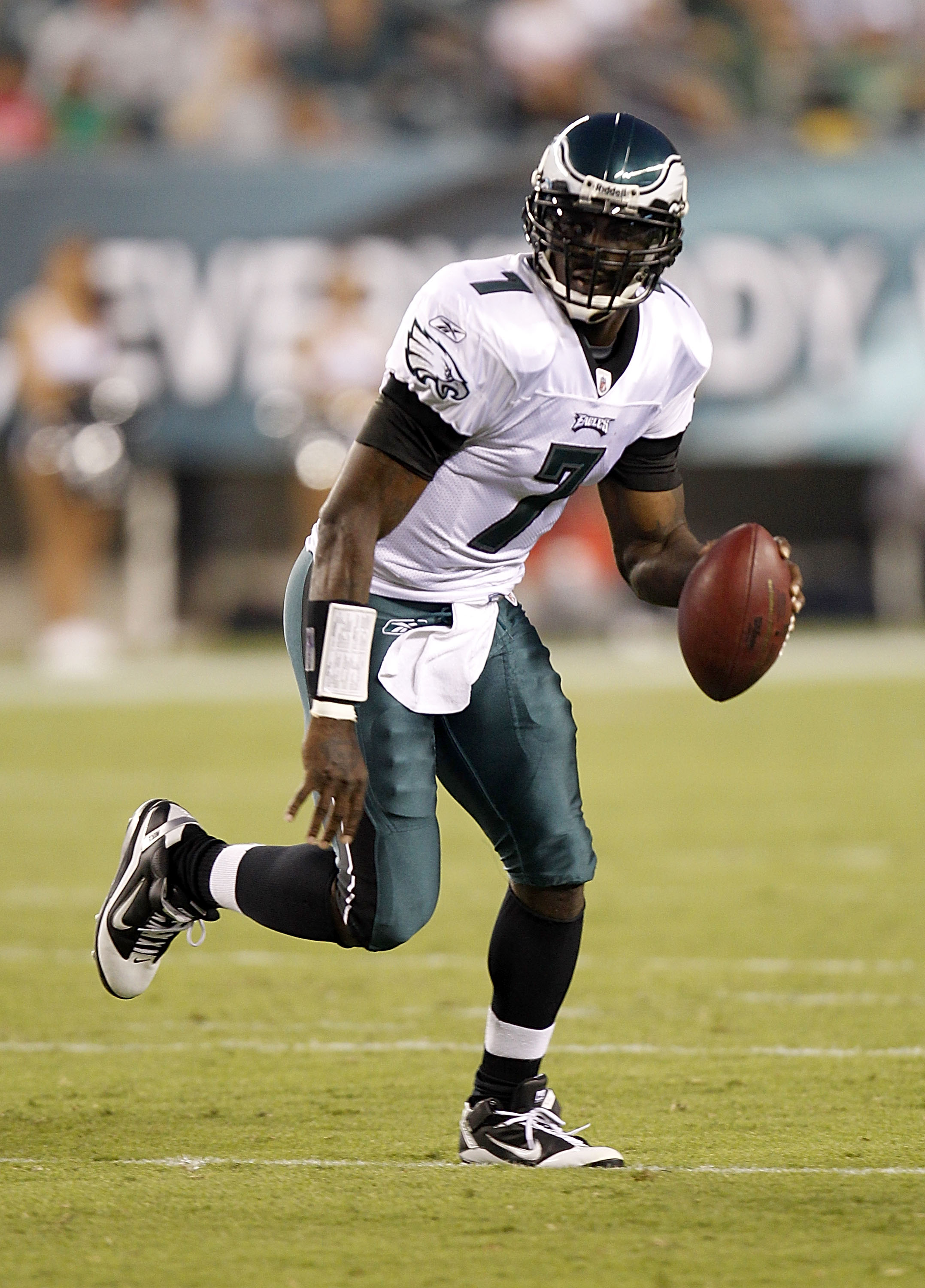 Former Atlanta Falcons and Philadelphia Eagles quarterback Michael Vick  wears one of his special edition New Era hats on sale in the NFL Shop at  the Super Bowl Experience on Thursday, Jan.