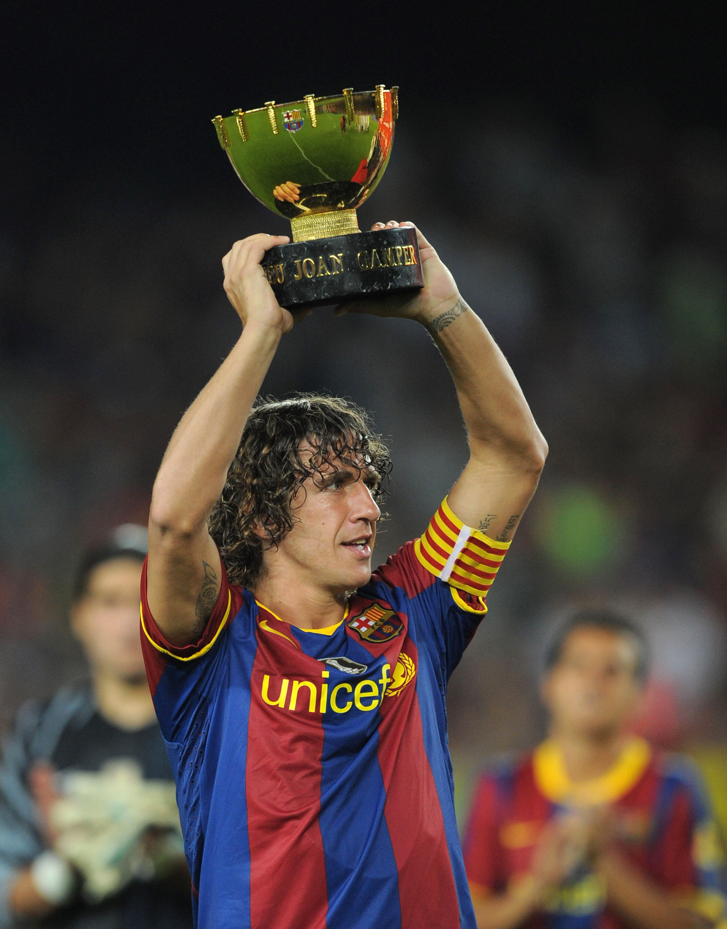 BARCELONA, SPAIN - AUGUST 25:  Carles Puyol of Barcelona holds the Joan Gamper Trophy after his team beat AC Milan in the Joan Gamper Trophy match between Barcelona and AC Milan at Camp Nou stadium on August 25, 2010 in Barcelona, Spain.  (Photo by Denis 