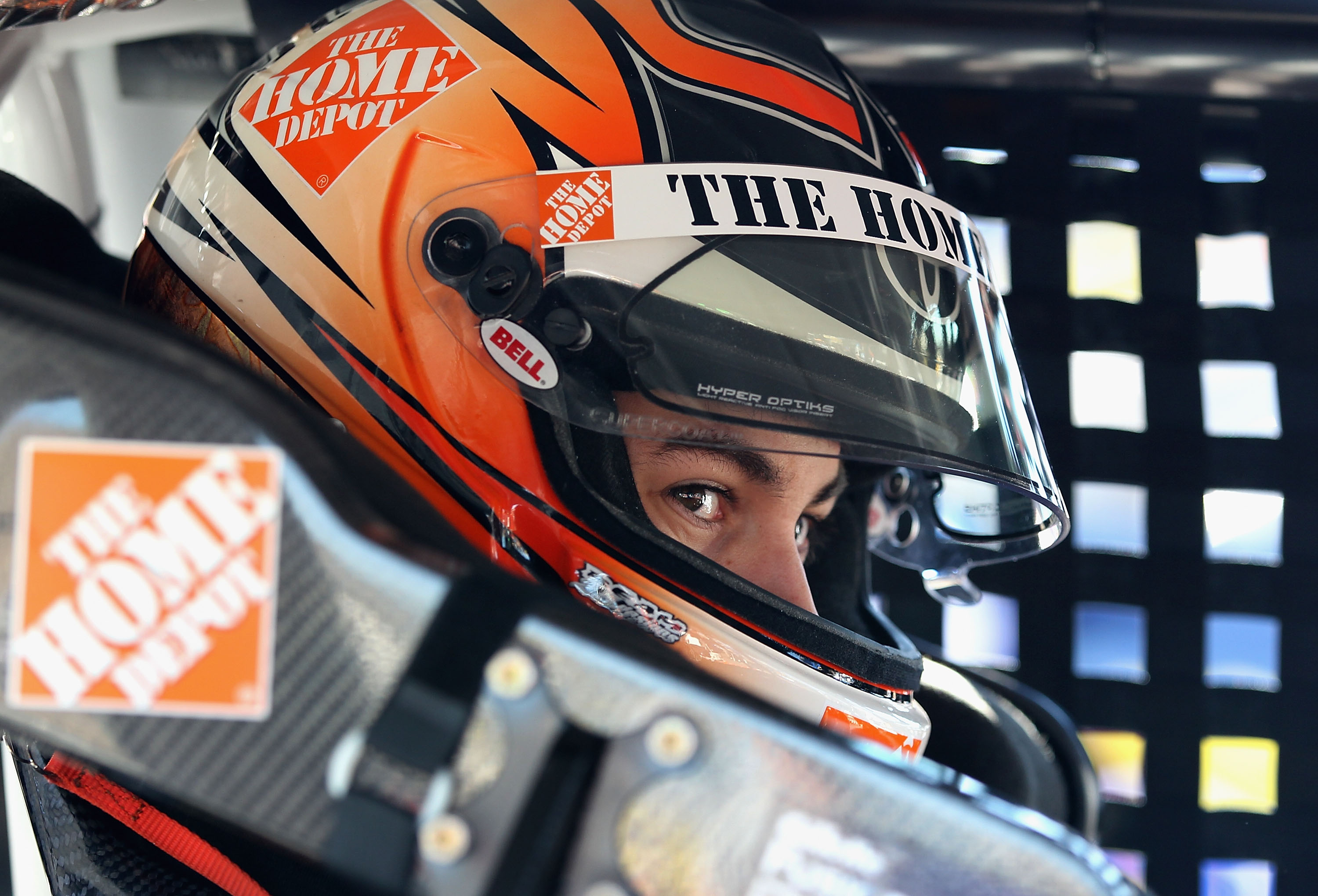 AVONDALE, AZ - NOVEMBER 12:  Joey Logano, driver of the #20 Home Depot Toyota, sits in his car during practice for the NASCAR Sprint Cup Series Kobalt Tools 500 at Phoenix International Raceway on November 12, 2010 in Avondale, Arizona.  (Photo by Christi