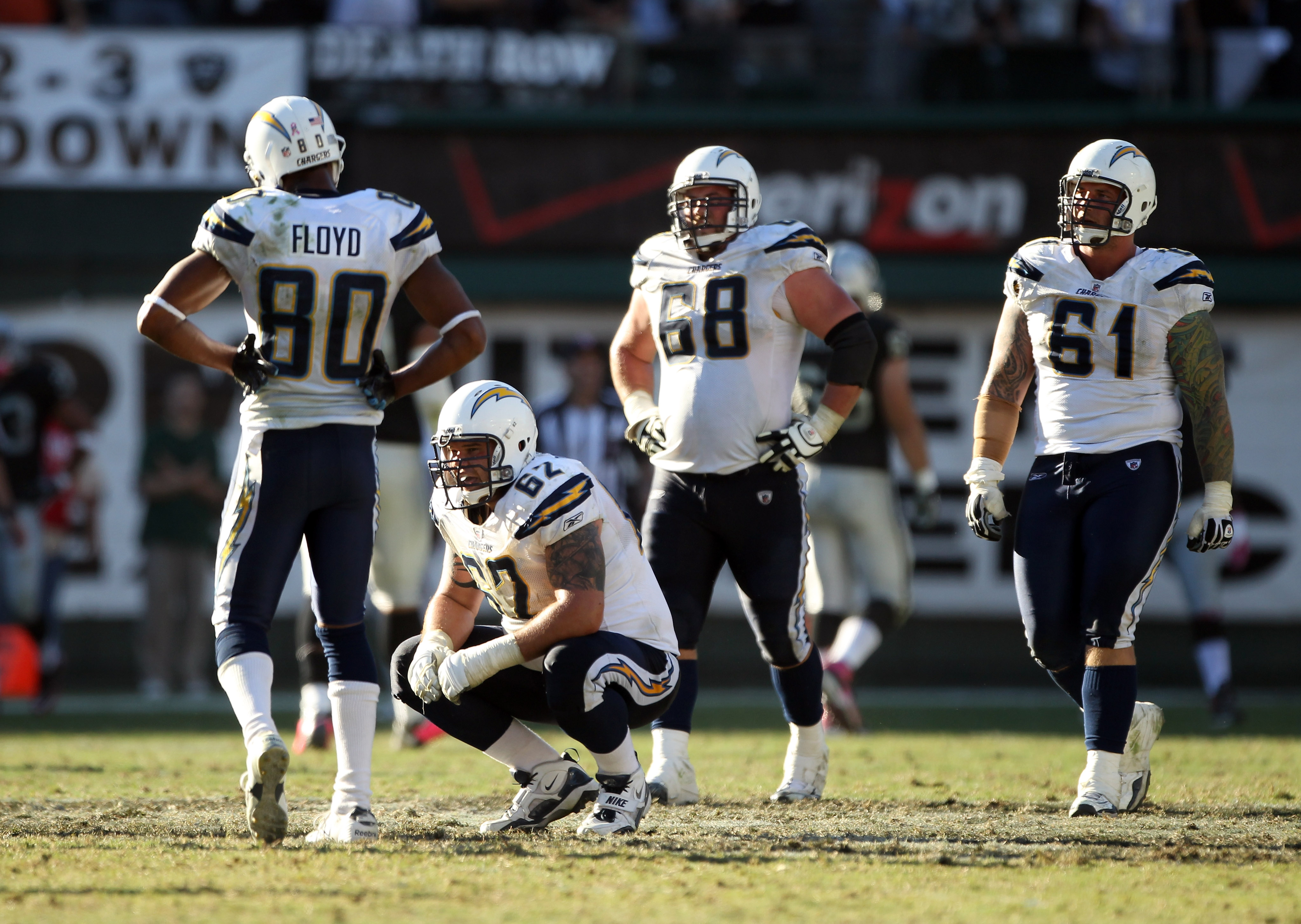 OAKLAND, CA - OCTOBER 10:   Malcom Floyd #80, Brandyn Dombrowski #62, Kris Dielman #68 and Nick Hardwick #61 of the San Diego Chargers react after Tyvon Branch #33 of the Oakland Raiders picked up a fumble and returned it for a touchdwon in the fourth qua