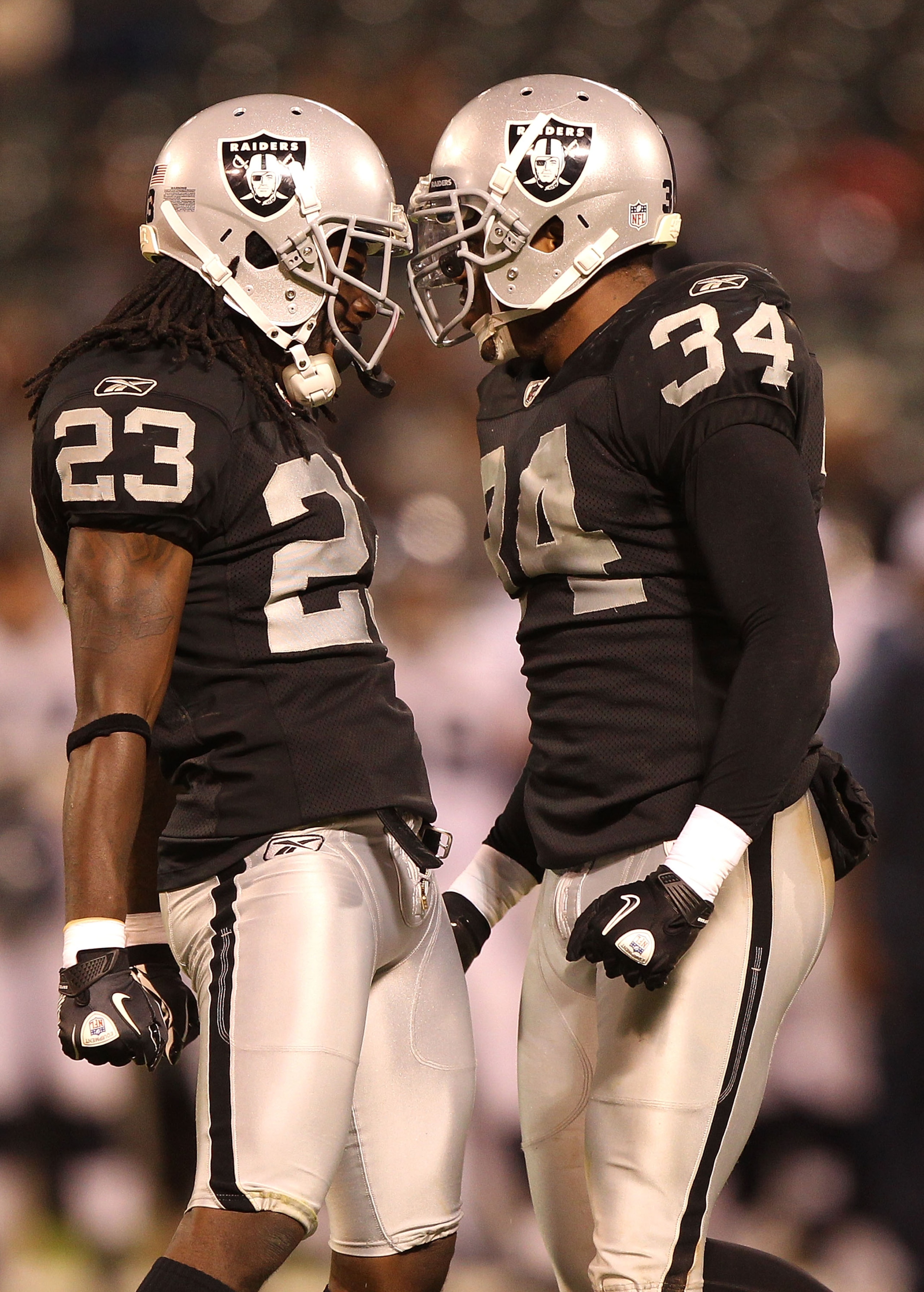 OAKLAND, CA - SEPTEMBER 2:  Jeremy Ware #23 and Mike Mitchell #34 of the Oakland Raiders celebrate against the Seattle Seahawks during an NFL preseason game at Oakland-Alameda County Coliseum on September 2, 2010 in Oakland, California.  (Photo by Jed Jac