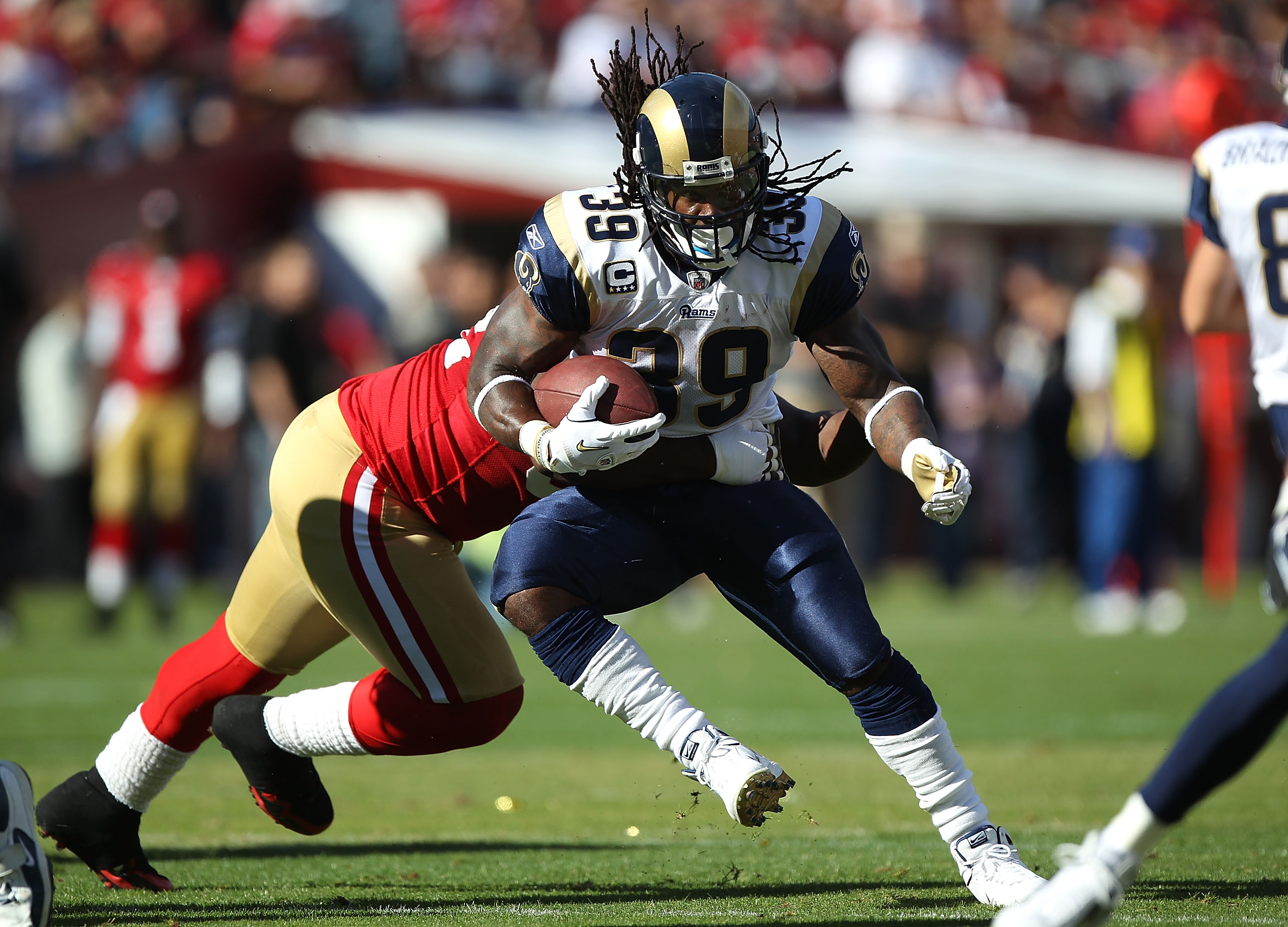 San Francisco 49ers WR Michael Crabtree (15) gains 19 yards on an Alex  Smith pass in the second quarter against the St. Louis Rams at Candlestick  Park in San Francisco on November