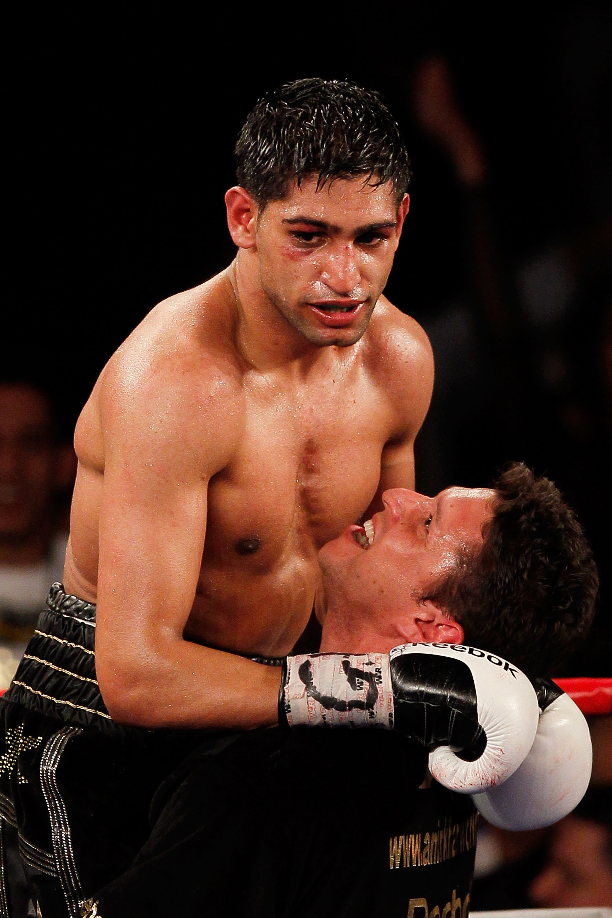 NEW YORK - MAY 15: Amir Khan (L) of Great Britain celebrates with a trainer after defeating Paulie Malignaggi by TKO in the 11th round of his WBA light welterweight title fight at Madison Square Garden on May 15, 2010 in New York City. (Photo by Chris T