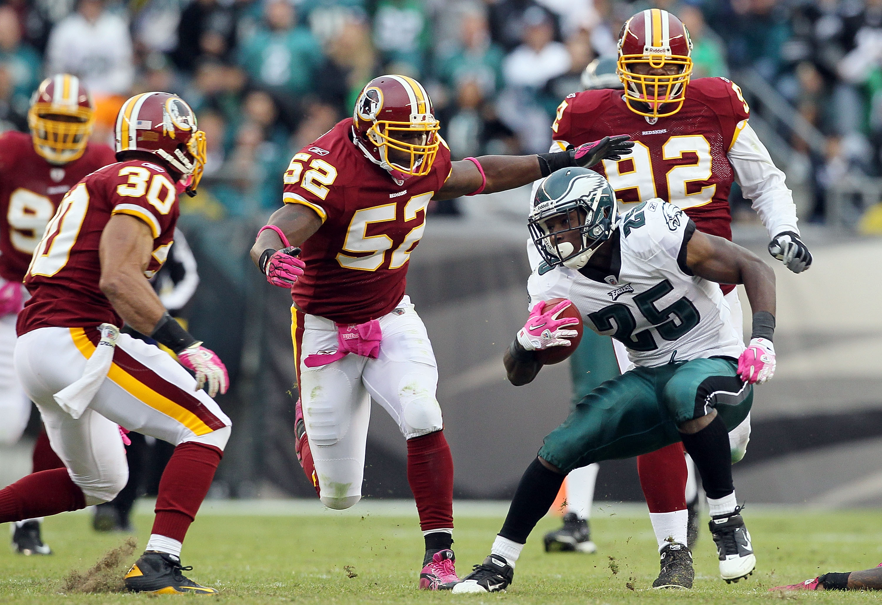 PHILADELPHIA - OCTOBER 03:  LeSean McCoy #25 of the Philadelphia Eagles looks for room to run the ball against Rocky McIntosh #52 of the Washington Redskins on October 3, 2010 at Lincoln Financial Field in Philadelphia, Pennsylvania.  (Photo by Jim McIsaa
