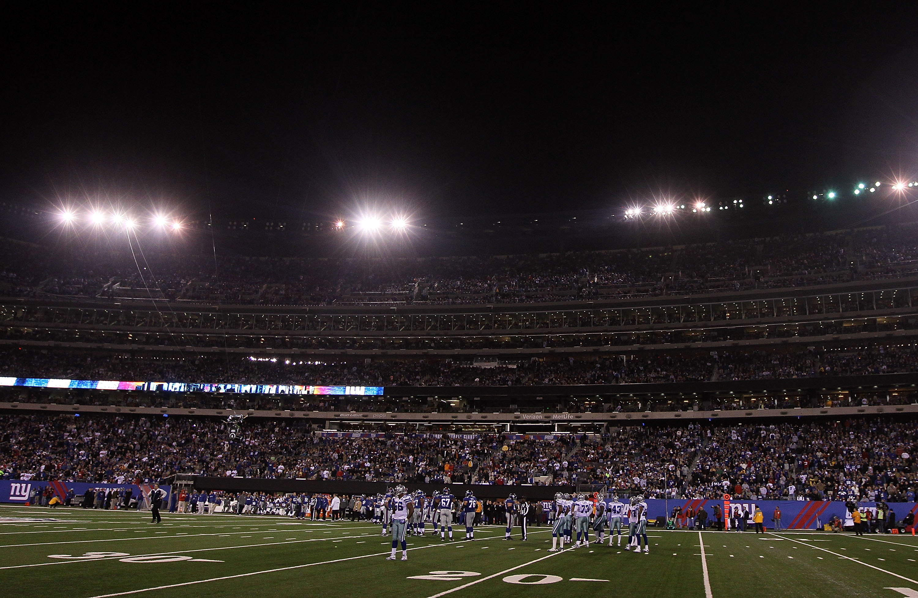 EAST RUTHERFORD, NJ - NOVEMBER 14: The Dallas Cowboys and the New York Giants stand on the field in the third quarter after several banks of stadium lights went out on November 14, 2010 at the New Meadowlands Stadium in East Rutherford, New Jersey. The C
