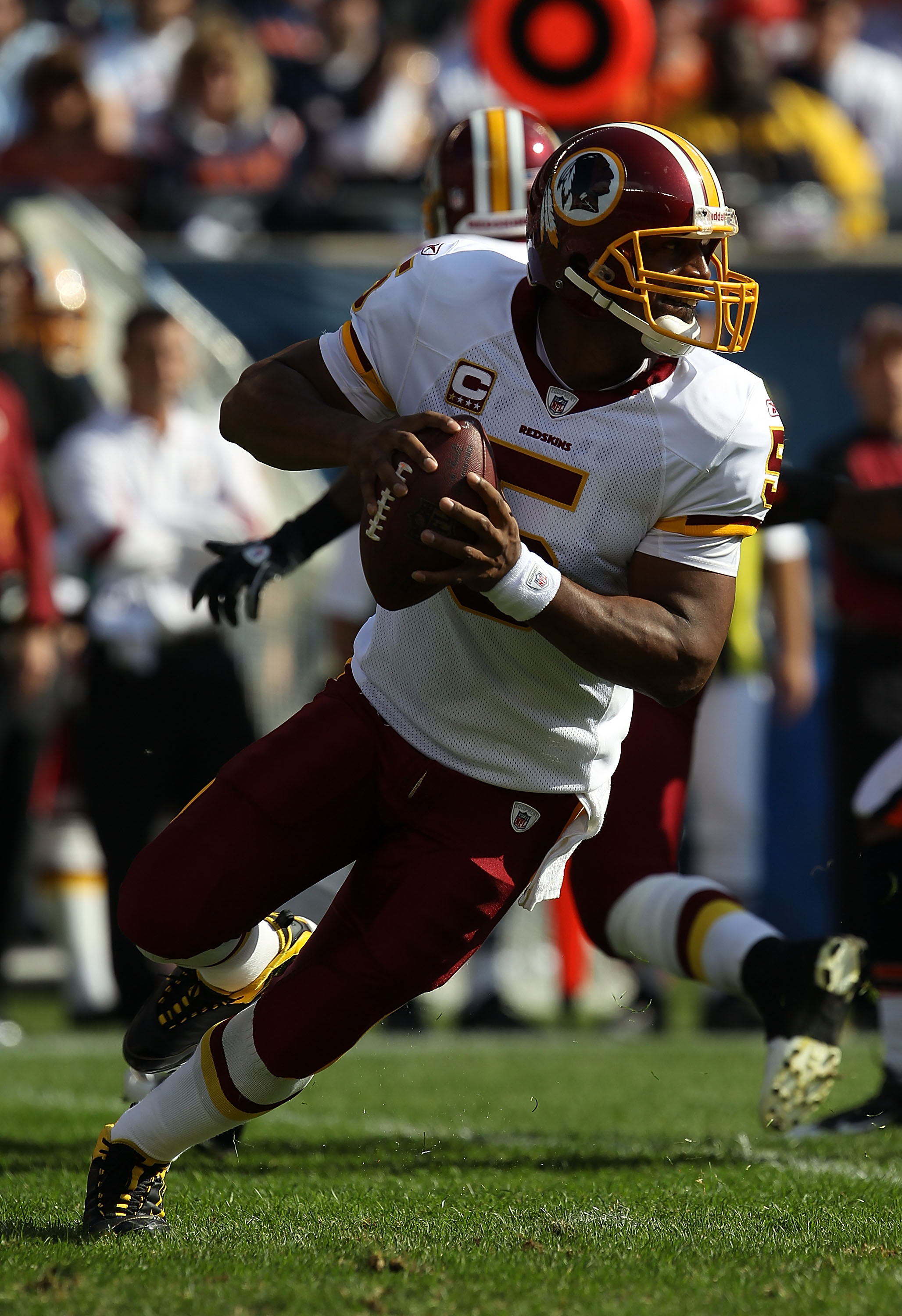 Washington Redskins new quarterback Donovan McNabb holds a jersey, after  head coach Mike Shanahan introduced McNabb to the team, at a press  conference at Redskins Park in Ashburn, Virginia on April 6