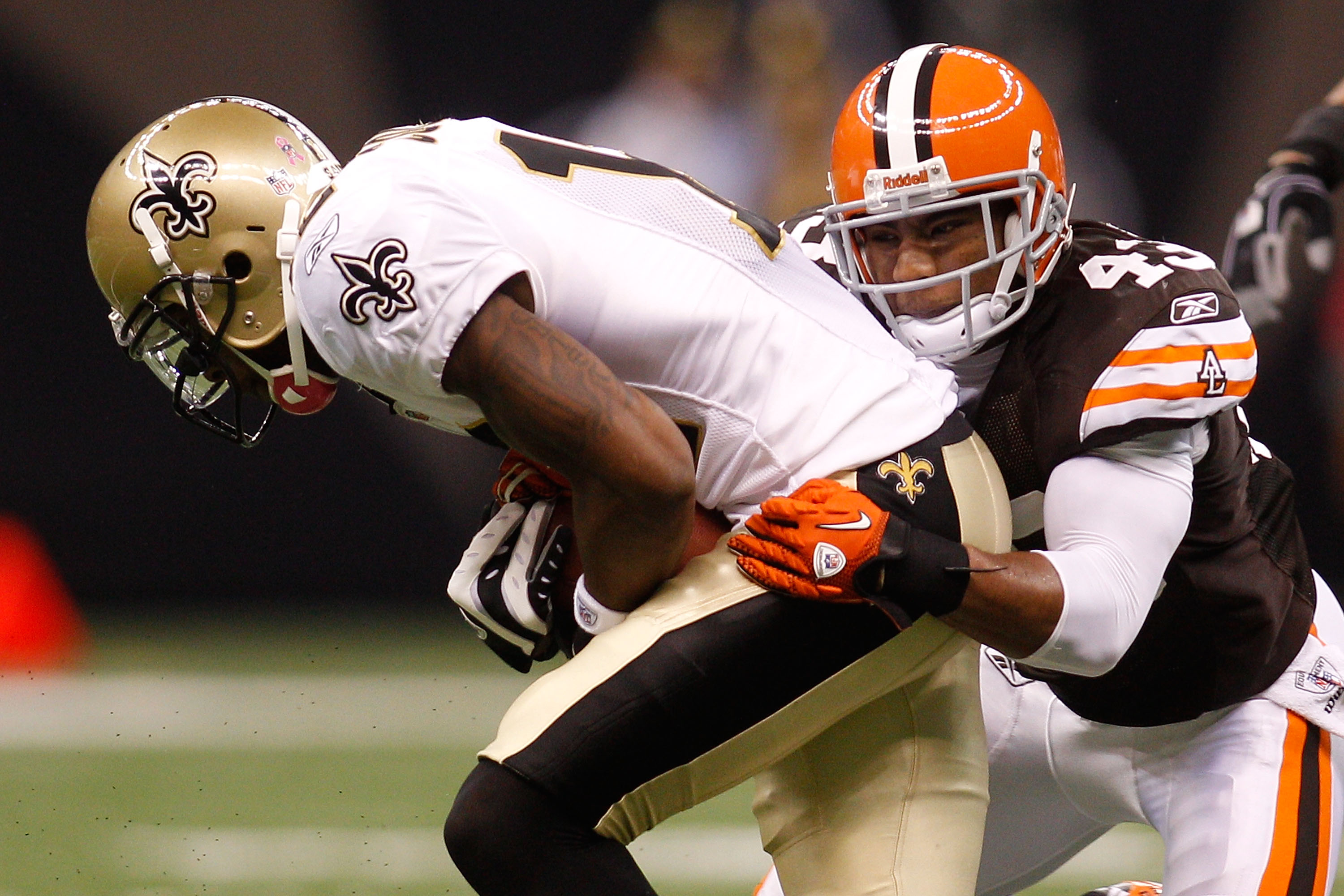 NEW ORLEANS - OCTOBER 24:  Marques Colston #12 of the New Orleans Saints is tackled by T.J. Ward #43 of the Cleveland Browns at the Louisiana Superdome on October 24, 2010 in New Orleans, Louisiana.  (Photo by Chris Graythen/Getty Images)