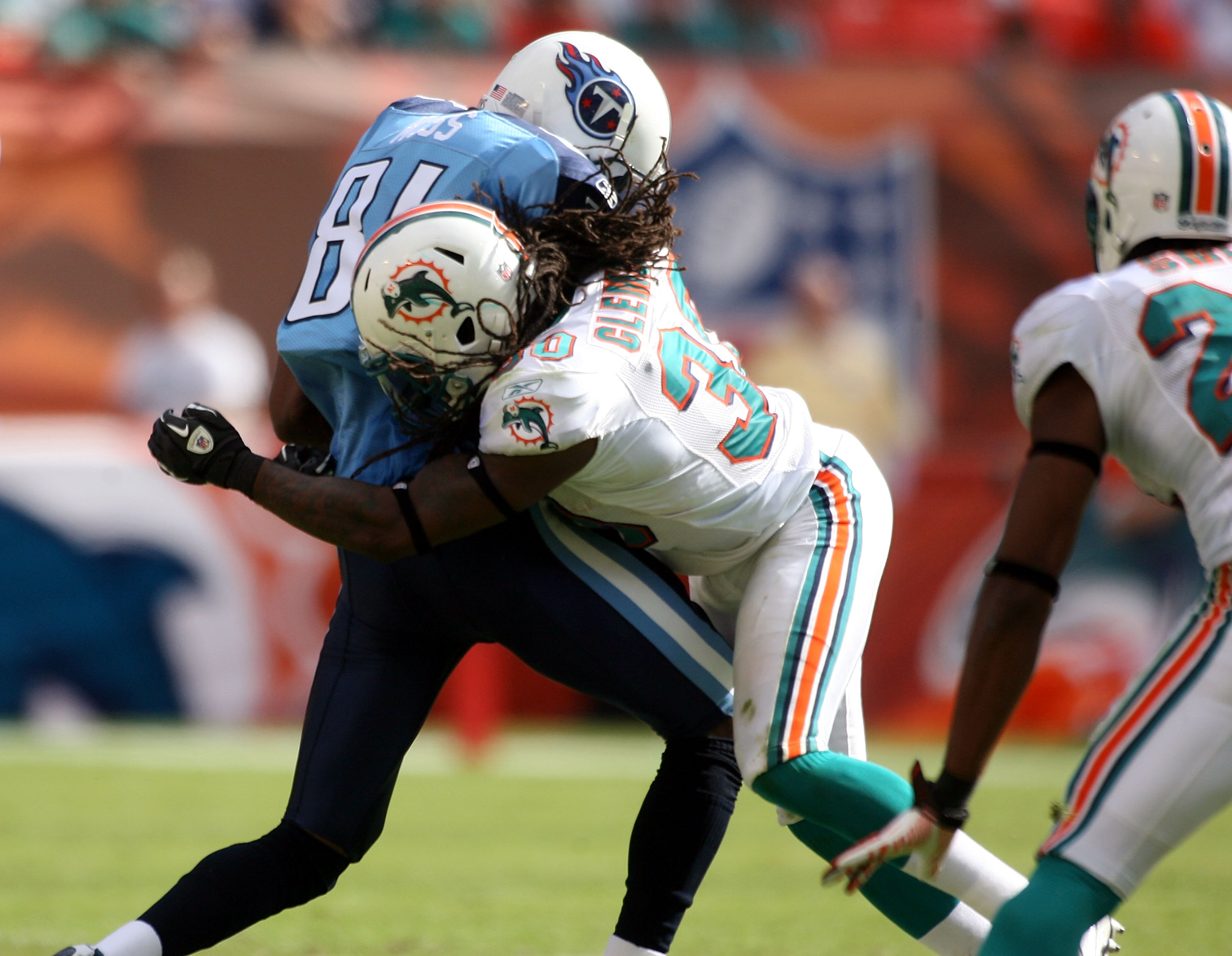 MIAMI - NOVEMBER 14: Receiver Randy Moss #84 of the Tennessee Titans is hit by Chris Clemons of the Miami Dolphins at Sun Life Stadium on November 14, 2010 in Miami, Florida. (Photo by Marc Serota/Getty Images)