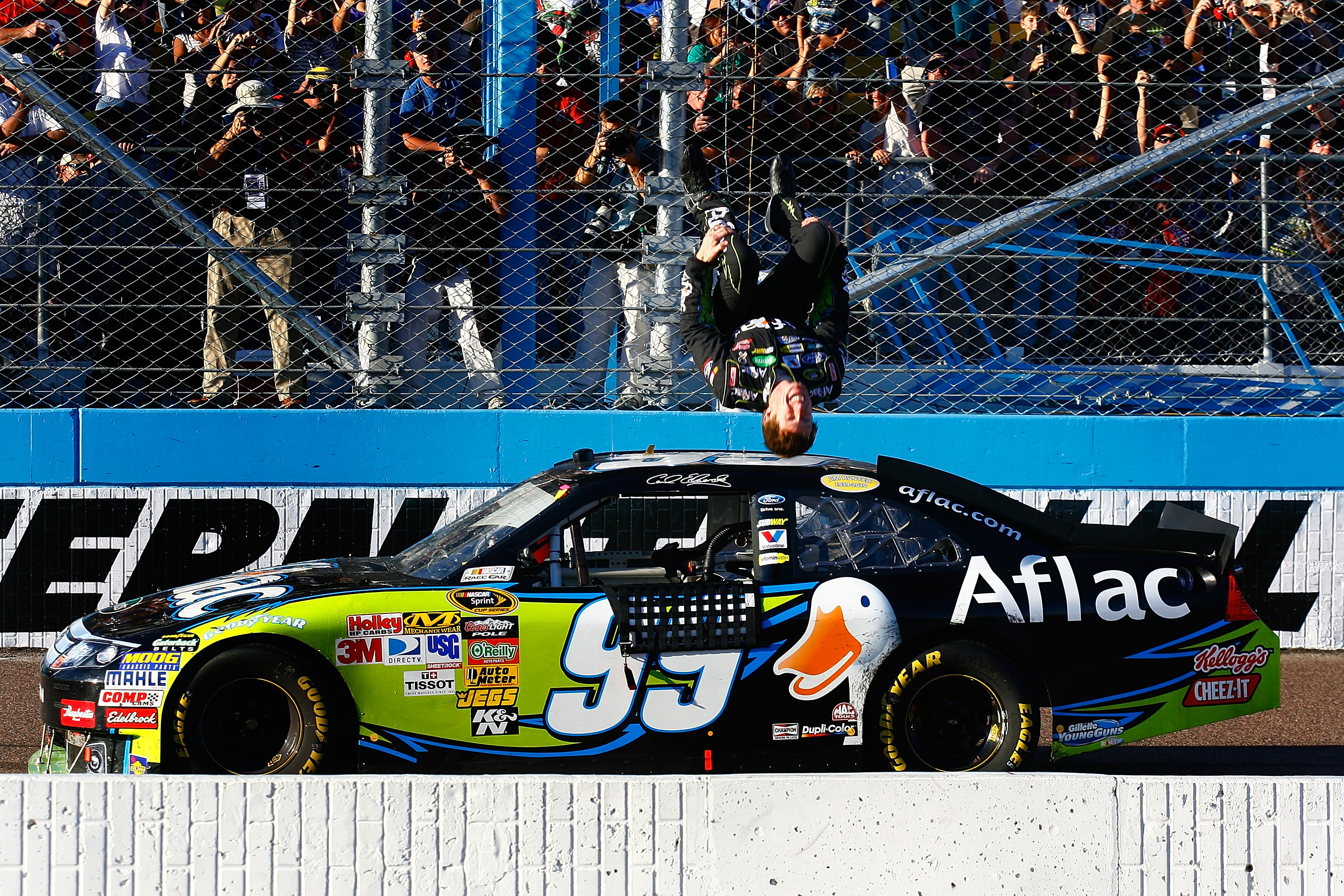 AVONDALE, AZ - NOVEMBER 14:  Carl Edwards, driver of the #99 Aflac Ford, performs a backflip after winning the NASCAR Sprint Cup Series Kobalt Tools 500 at Phoenix International Raceway on November 14, 2010 in Avondale, Arizona.  (Photo by Jason Smith/Get