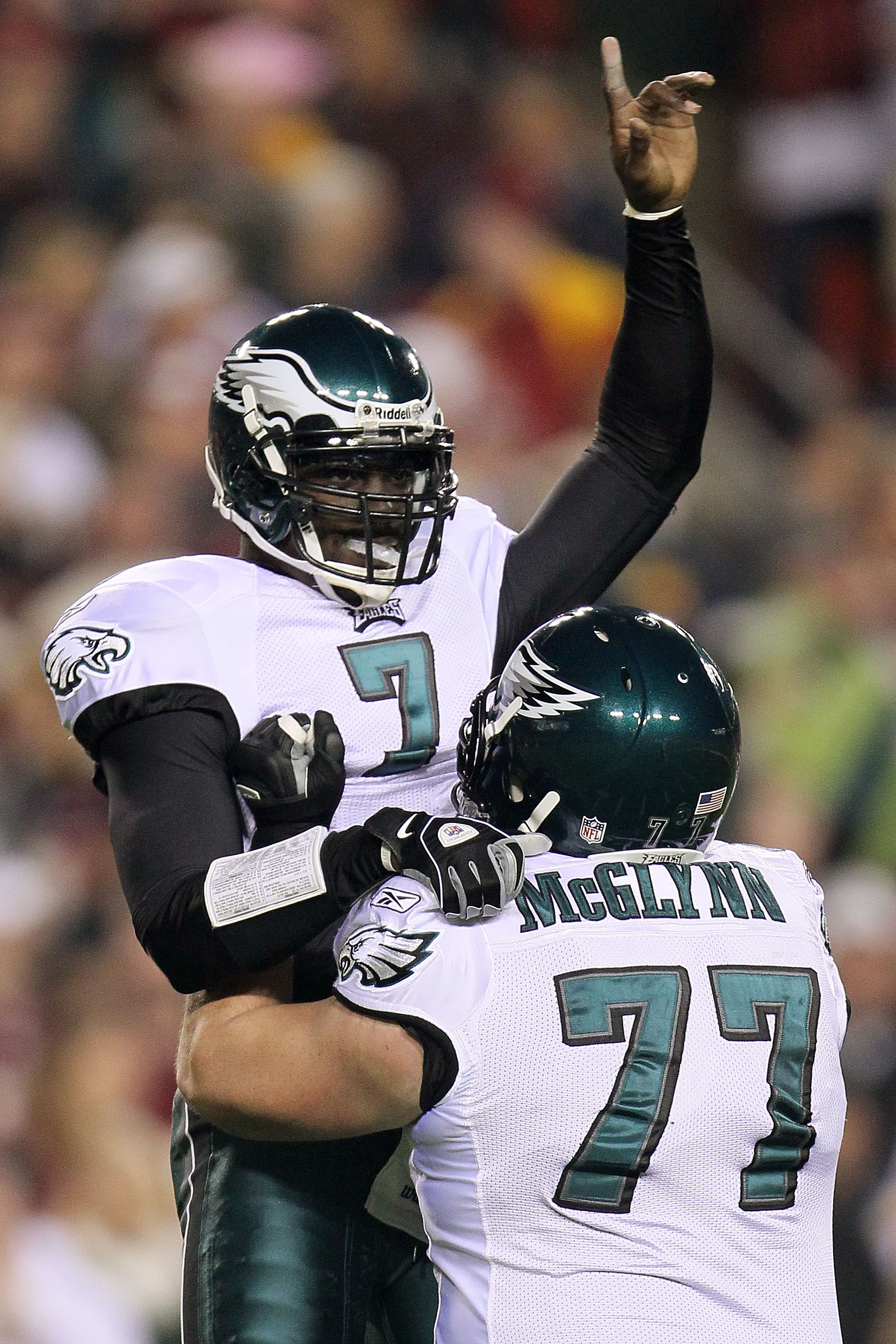 LANDOVER, MD - NOVEMBER 15:  Michael Vick #7 of the Philadelphia Eagles celebrates with team mate Mike McGlynn #77 after throwing his teams first touchdown against the Washington Redskins on November 15, 2010 at FedExField in Landover, Maryland.  (Photo b