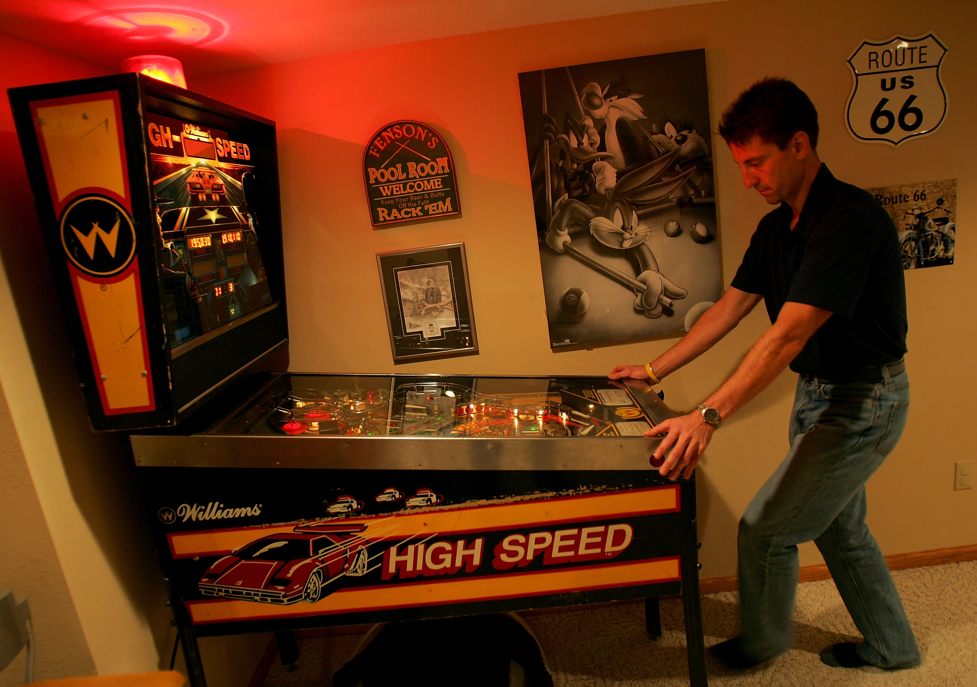 BEMIDJI, MN - SEPTEMBER 28:  Pete Fenson plays pinball in his basement September 28, 2005 in Bemidji, Minnesota. Pete Fenson is a curler and will represent the US at the Olympic games in Torino. (Photo by Matthew Stockman/Getty Images)