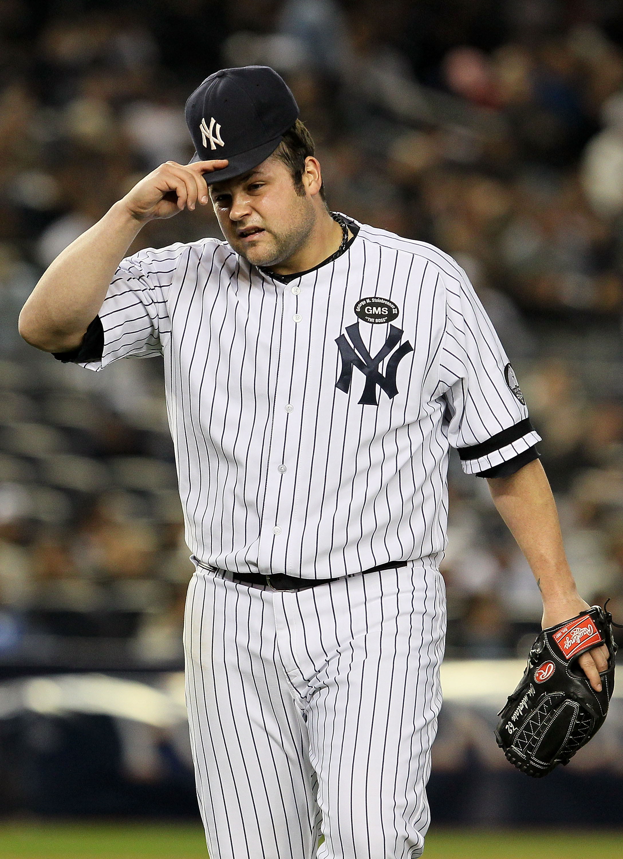 NEW YORK - OCTOBER 19:  Joba Chamberlain #62 of the New York Yankees reacts as he walks back to the dugout at the end of the top of the eighth inning against the Texas Rangers in Game Four of the ALCS during the 2010 MLB Playoffs at Yankee Stadium on Octo