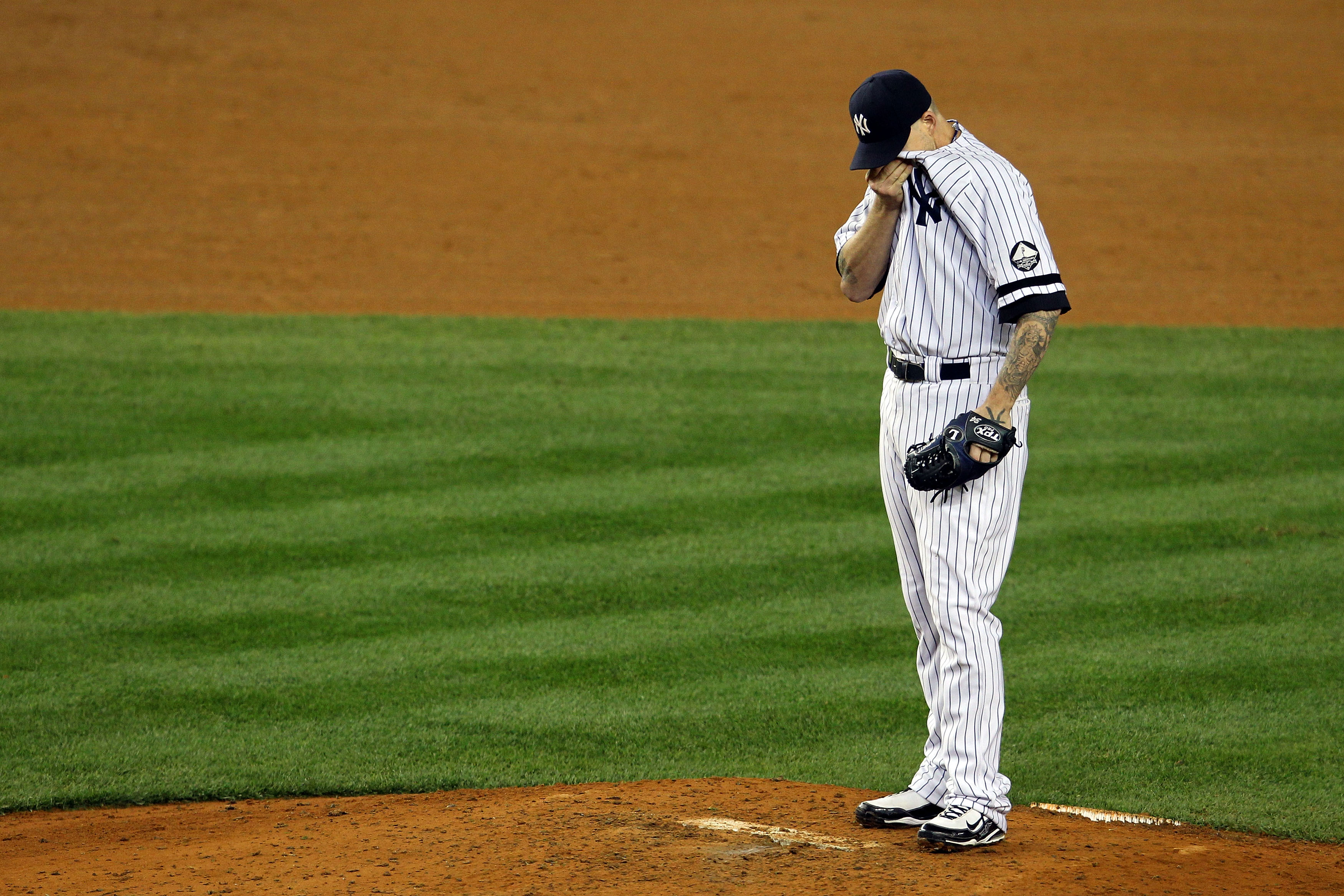NEW YORK - OCTOBER 19:  A.J. Burnett #34 of the New York Yankees reacts after giving up a three-run home run to Bengie Molina #11 of the Texas Rangers in the top of the sixth inning in Game Four of the ALCS during the 2010 MLB Playoffs at Yankee Stadium o