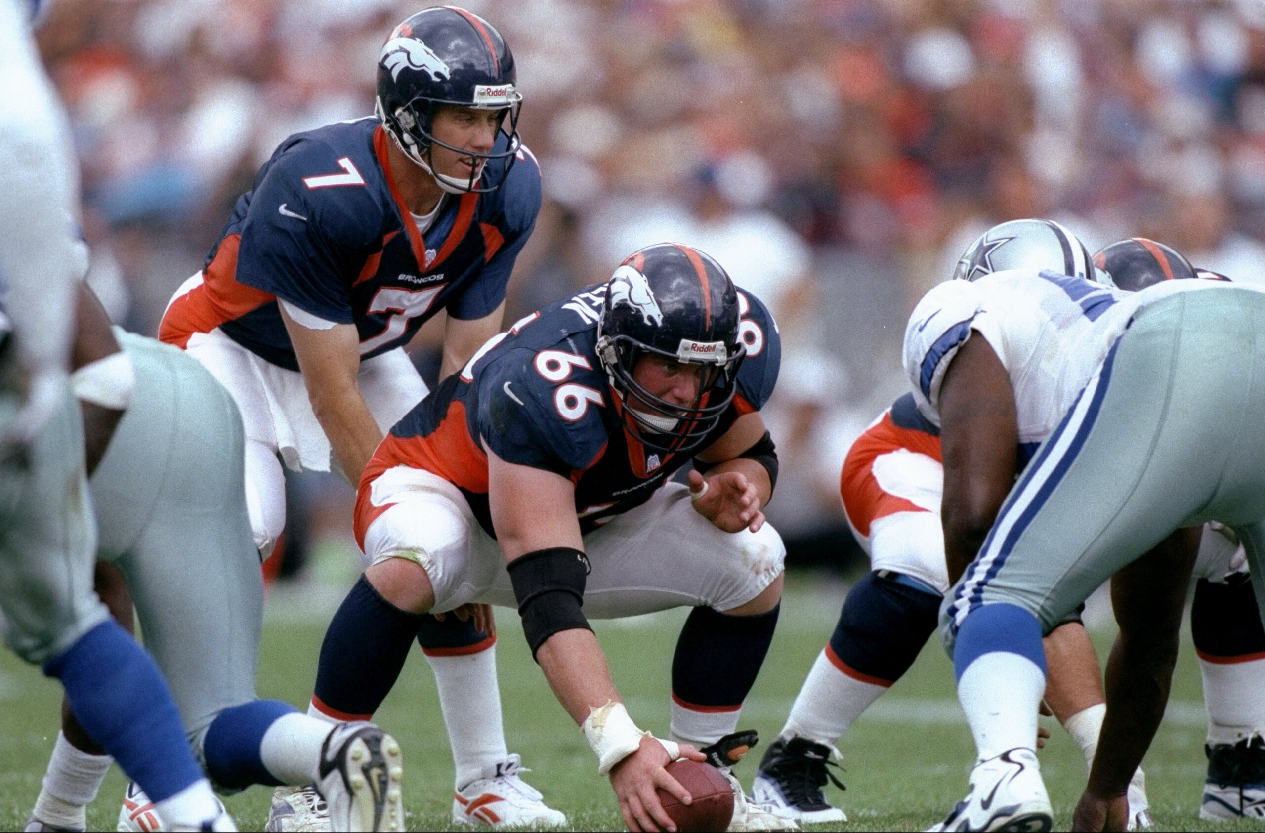 13 Sep 1998:  Quarterback John Elway #7 and center Tom Nalen #66 of the Denver Broncos in action during the game against the Dallas Cowboys at the Mile High Stadium in Denver, Colorado. The Broncos defeated the Cowboys 42-23. Mandatory Credit: Brian Bahr
