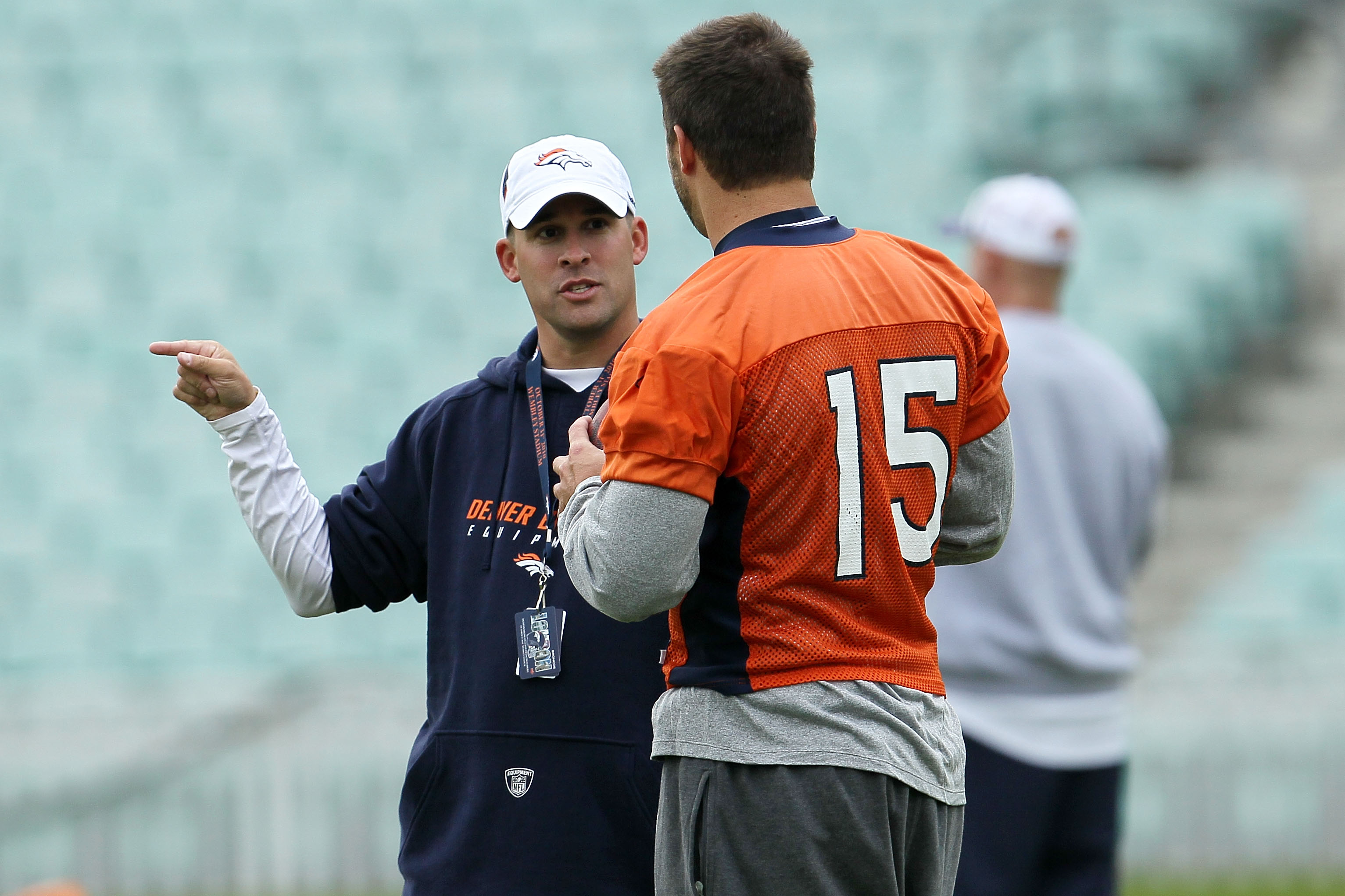LONDON, ENGLAND - OCTOBER 29:  Head coach of the Denver Broncos Josh McDaniels talks with Tim Tebow #15  during a team training session at The Brit Oval on October 29, 2010 in London, England. The Denver Broncos will play the San Francisco 49ers at Wemble