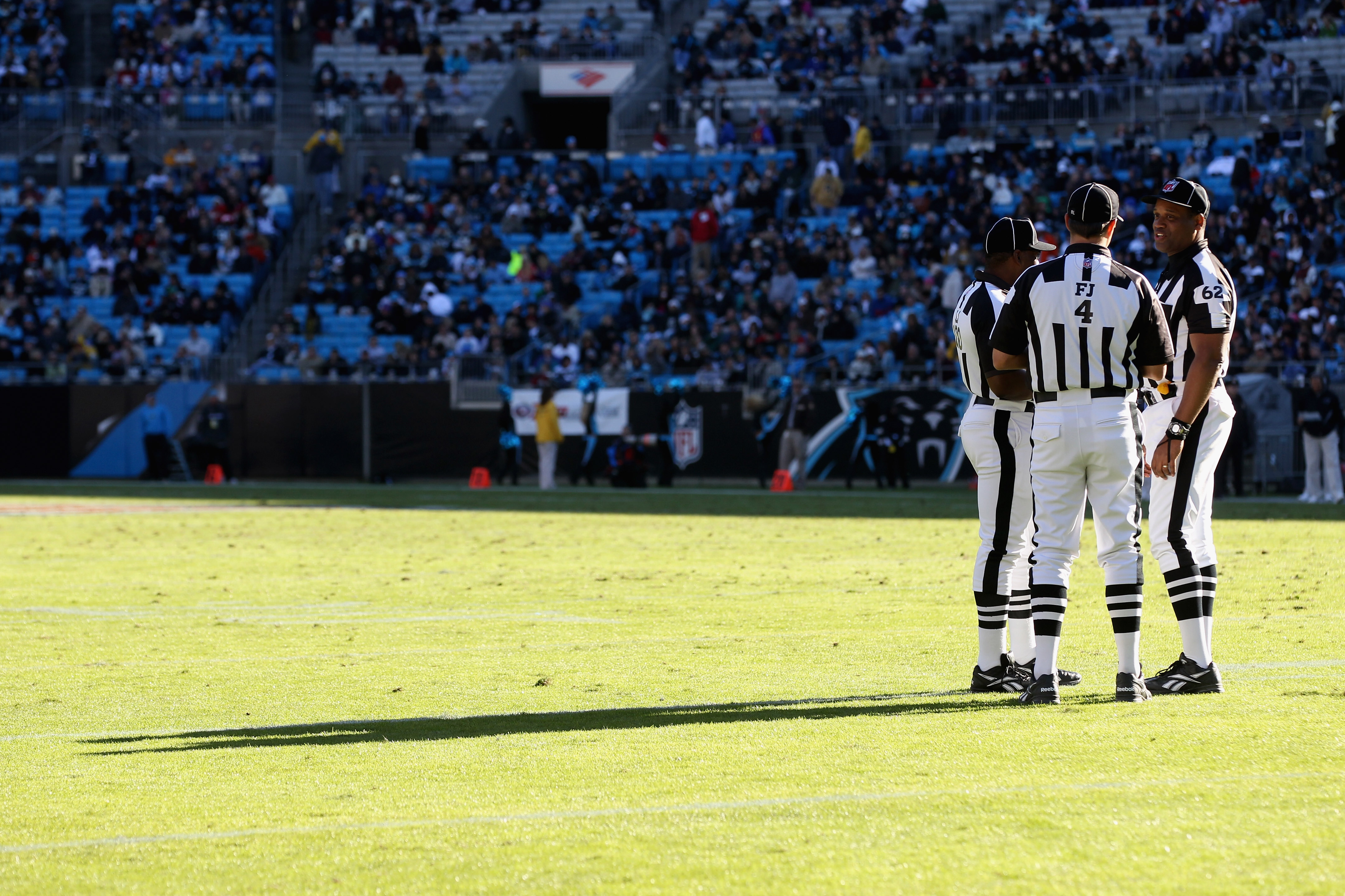 CHARLOTTE, NC - NOVEMBER 07:  A group of referees huddle during their game between the New Orleans Saints and the Carolina Panthers during their game at Bank of America Stadium on November 7, 2010 in Charlotte, North Carolina.  (Photo by Streeter Lecka/Ge