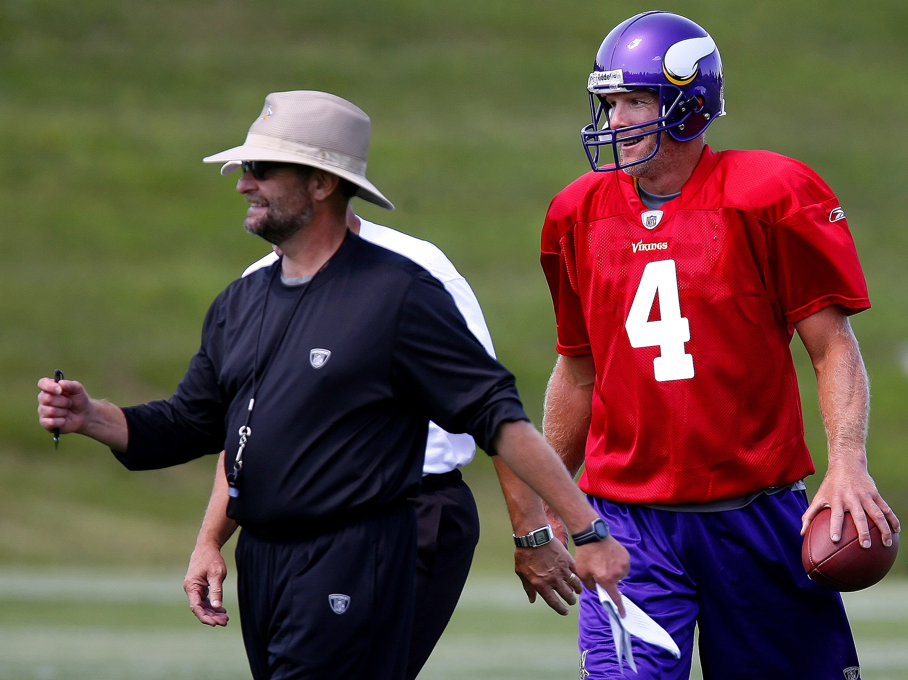 EDEN PRAIRIE, MN - AUGUST 18: Minnesota Vikings Head Coach Brad Childress (L) walks with Brett Favre #4 after finishing a passing drill during a Minnesota Vikings practice session on August 18, 2009 at Winter Park in Eden Prairie, Minnesota. Favre has r