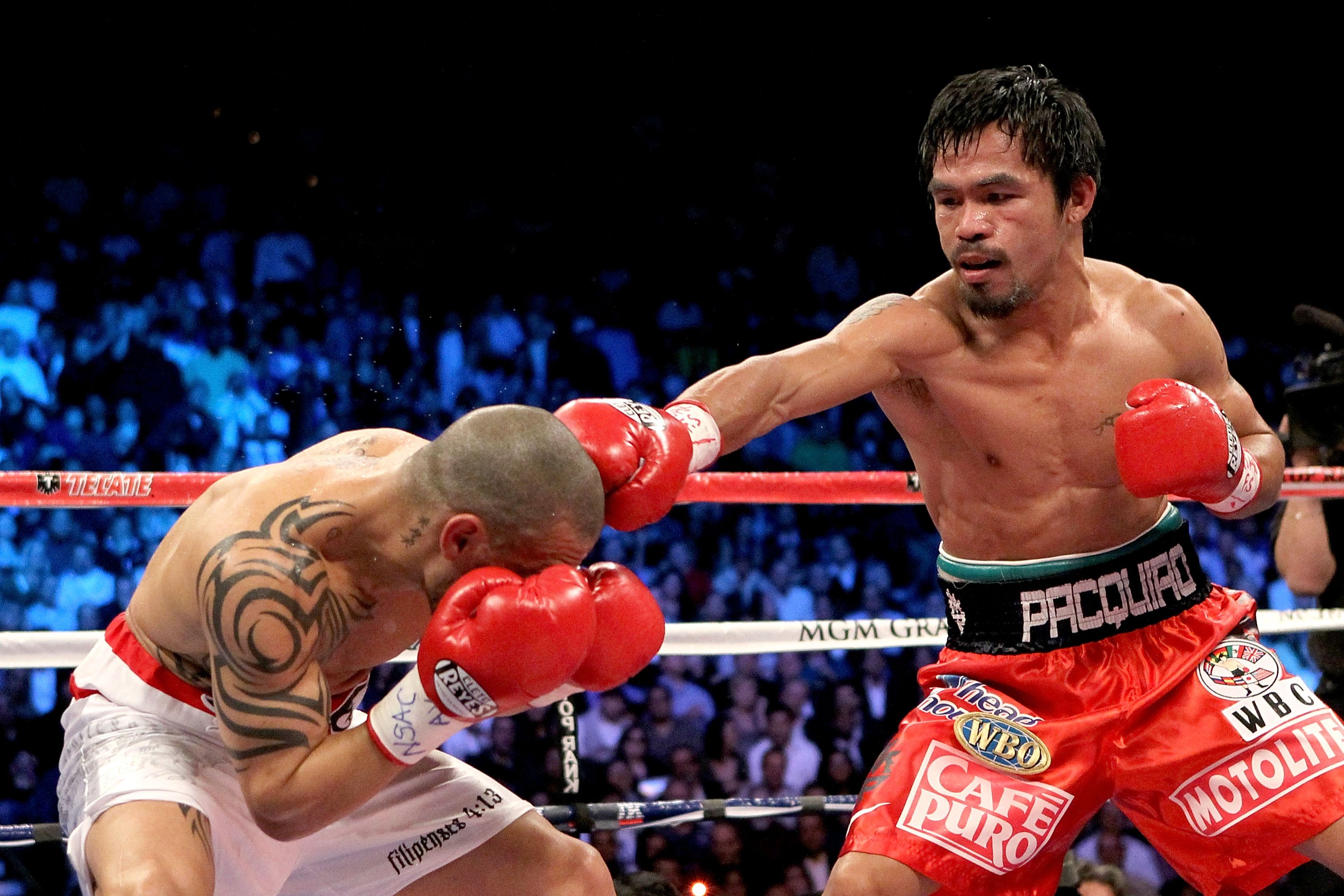 LAS VEGAS - NOVEMBER 14: (R-L) Manny Pacquiao throws a right to the head of Miguel Cotto during their WBO welterweight title fight at the MGM Grand Garden Arena on November 14, 2009 in Las Vegas, Nevada. (Photo by Al Bello/Getty Images)