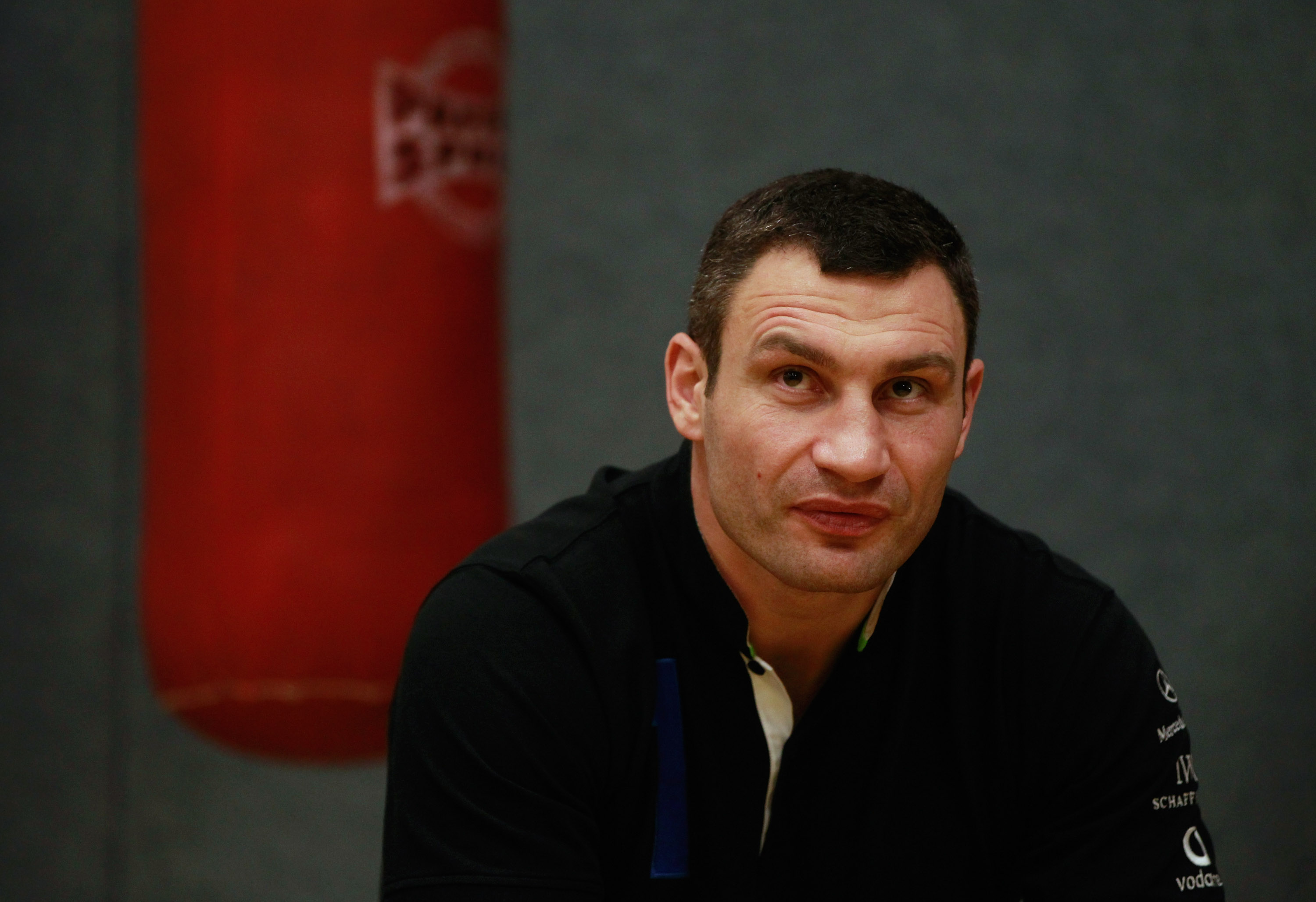 BERLIN - NOVEMBER 16: Pro boxer Vitali Klitschko sits prior to coaching young boxers at the 'Kick im Boxring' at the TC Gruen Weiss boxing hall in Treptow district on November 16, 2010 in Berlin, Germany. The 'Kick im Boxring' project encourages youth in