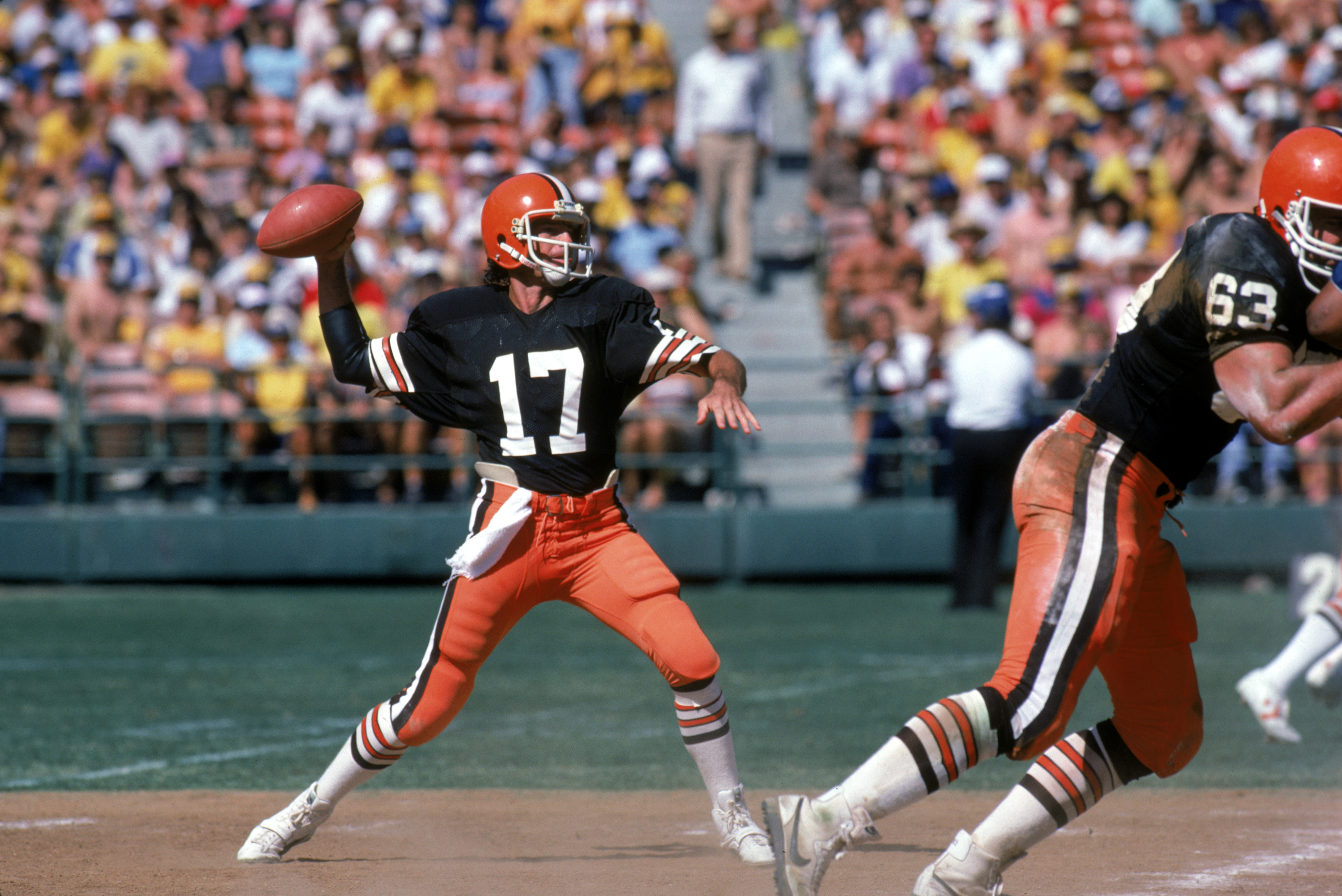 SAN DIEGO - SEPTEMBER 25:  Quarterback Brian Sipe #17 of the Cleveland Browns throws a pass under the protection of offensive tackle Cody Risien #63 during a game against the San Diego Chargers at Jack Murphy on September 25, 1983 in San Diego, California