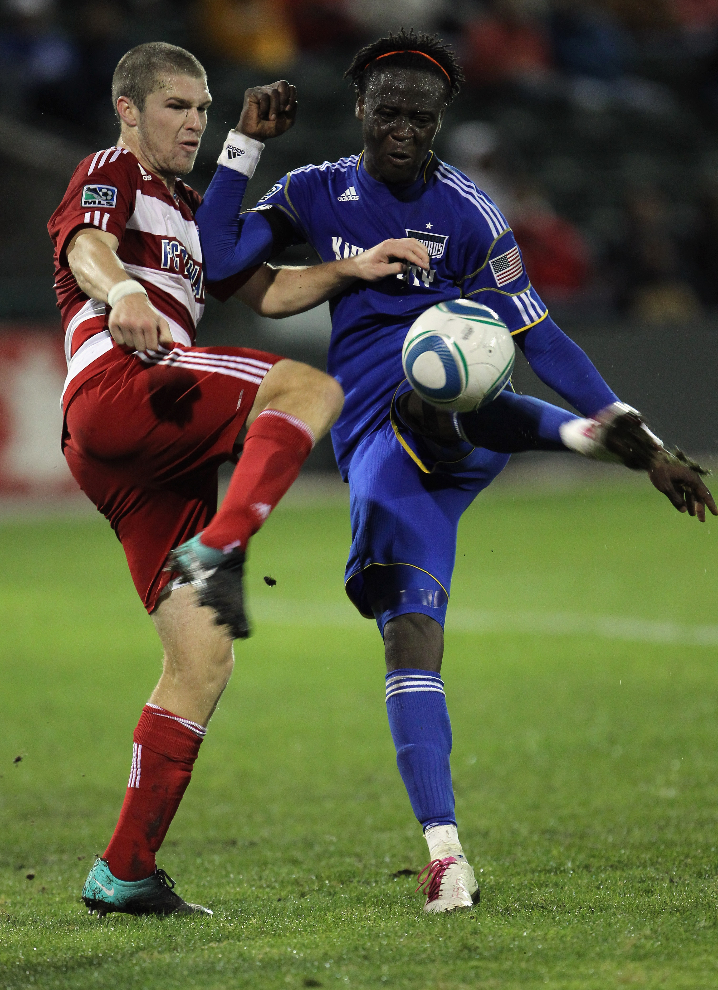 KANSAS CITY, MO - SEPTEMBER 25:  Kei Kamara #23 of the Kansas City Wizards shoots as Kyle Davies #15 of FC Dallas defends during the game on September 25, 2010 at Community America Ballpark in Kansas City, Missouri.  (Photo by Jamie Squire/Getty Images)