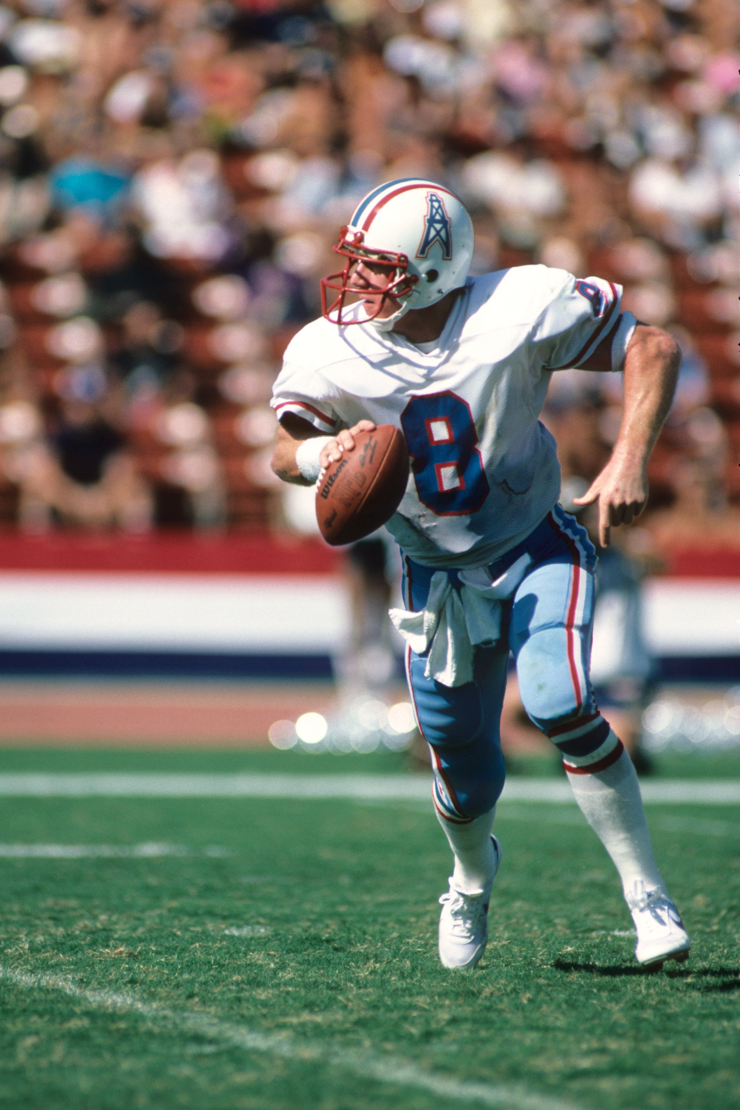 LOS ANGELES - NOVEMBER 11:  Quaterback Archie Manning #8 of the Houston Oilers rolls out to pass during the game against the Los Angeles Raiders at the Los Angeles Memorial Coliseum on November 11, 1983 in Los Angeles, California.  The Raiders won 20-6.