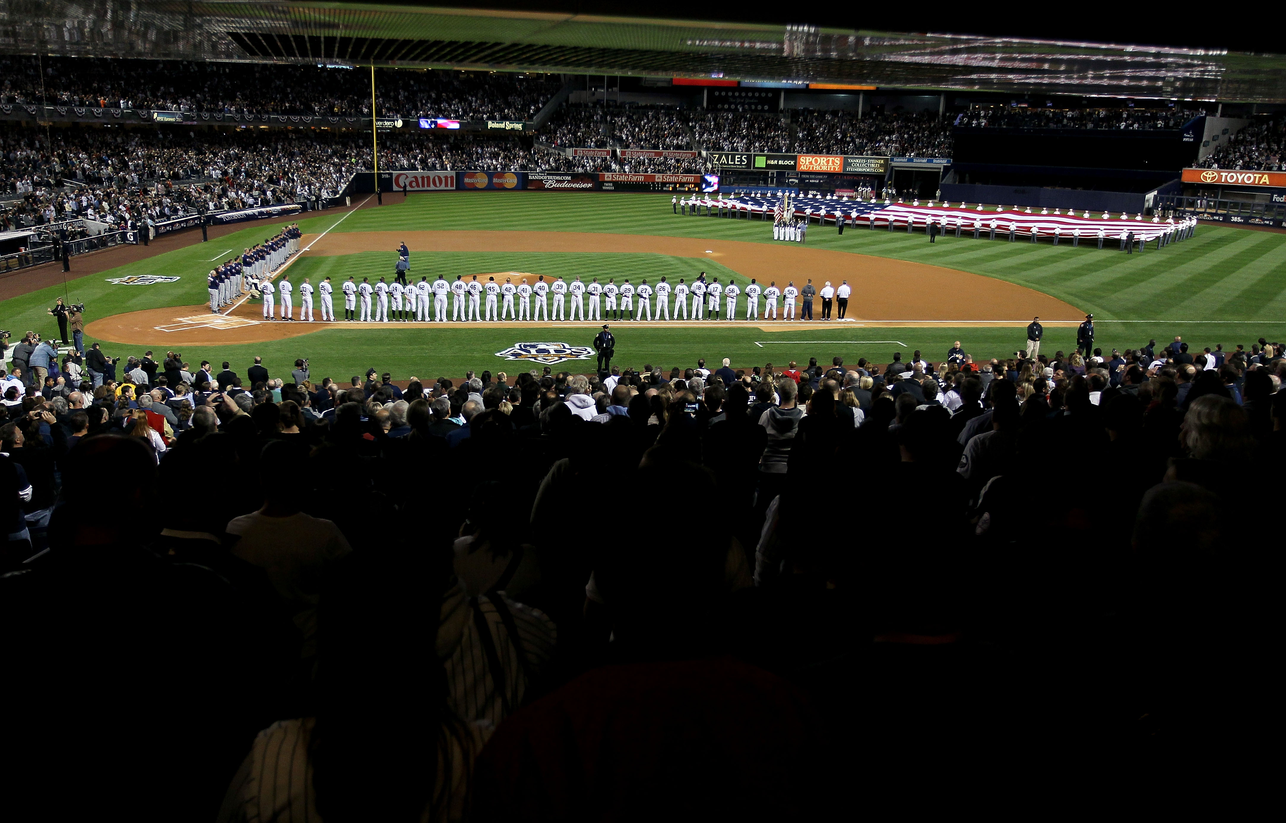 NEW YORK - OCTOBER 09:  The New York Yankees and the Minnesota Twins stand for the performance of the National Anthem during Game Three of the ALDS part of the 2010 MLB Playoffs at Yankee Stadium on October 9, 2010 in the Bronx borough of New York City.
