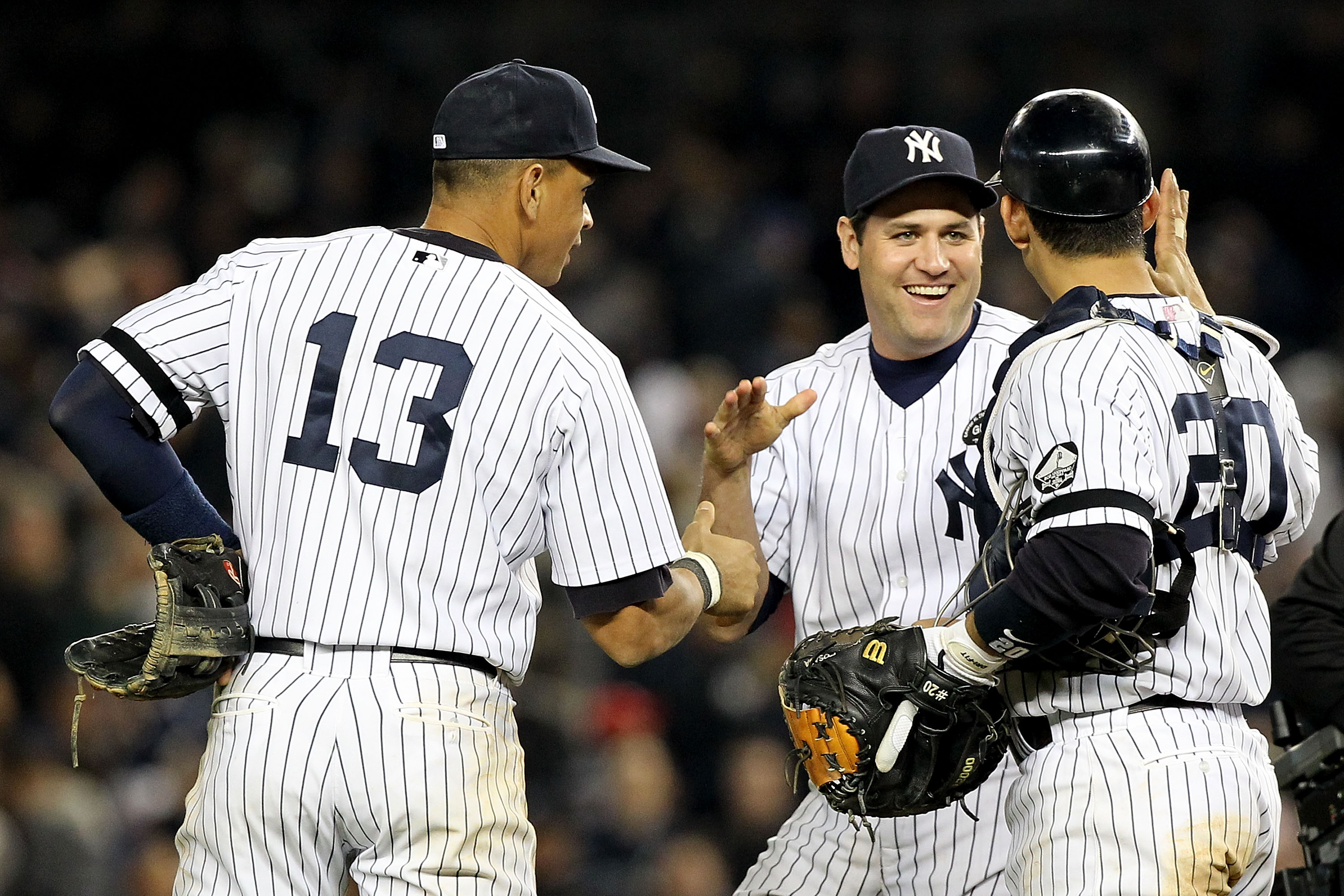 NEW YORK - OCTOBER 20:  Alex Rodriguez #13, Lance Berkman #17 and Jorge Posada #20 of the New York Yankees celebrate after the Yankees won 7-2 against the Texas Rangers in Game Five of the ALCS during the 2010 MLB Playoffs at Yankee Stadium on October 20,
