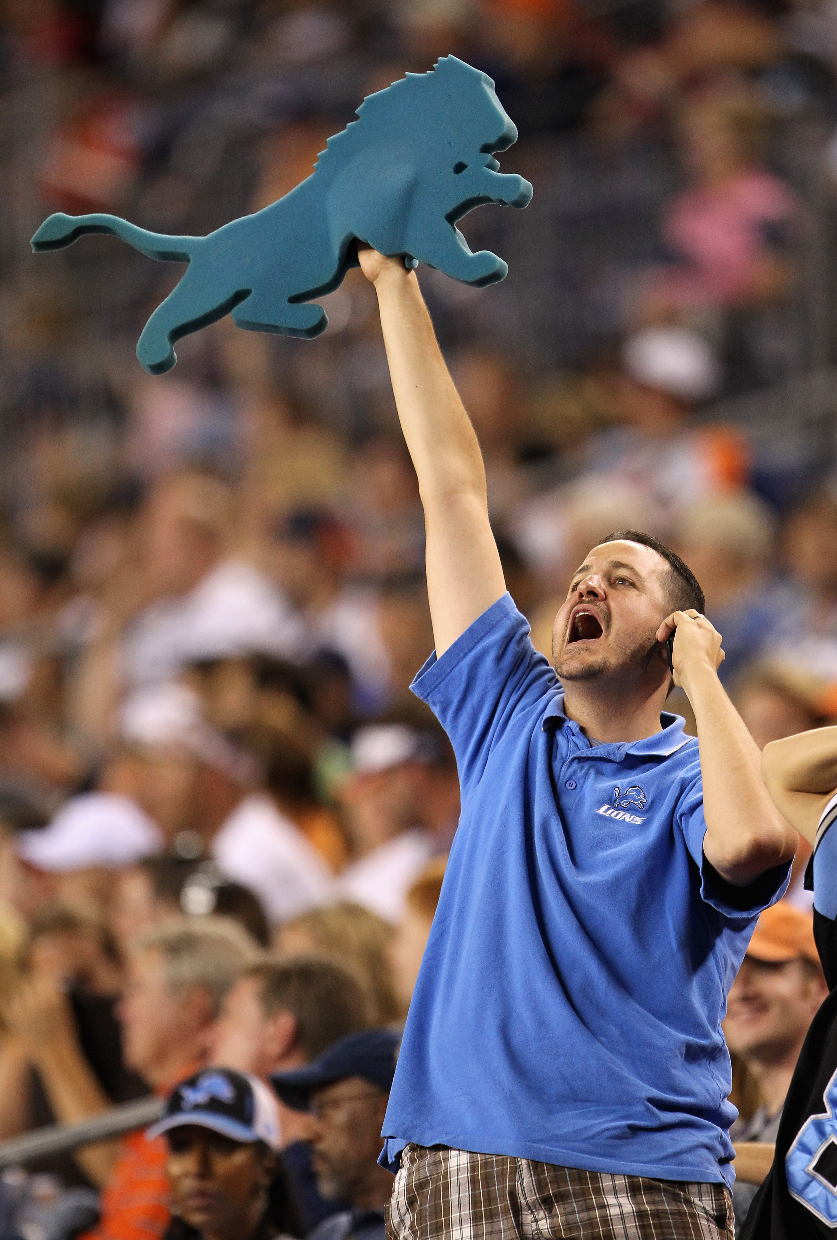 DENVER - AUGUST 21:  A Detroit Lions fans celebrates as the Lions face the Denver Broncos during preseason NFL action at INVESCO Field at Mile High on August 21, 2010 in Denver, Colorado. The Lions defeated the Broncos 25-20.  (Photo by Doug Pensinger/Get
