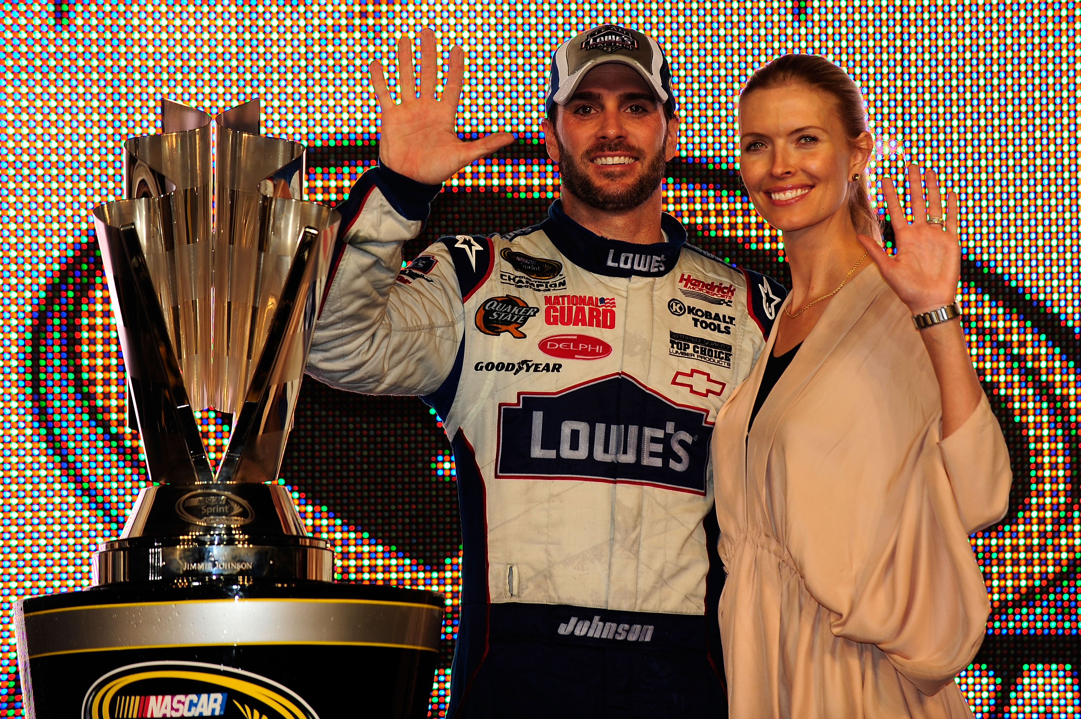 HOMESTEAD, FL - NOVEMBER 21:  Jimmie Johnson (L), driver of the #48 Lowe's Chevrolet, poses with his wife Chandra after finishing in second place in the Ford 400 to clinch his fifth consecutive NASCAR Sprint Cup championship at Homestead-Miami Speedway on