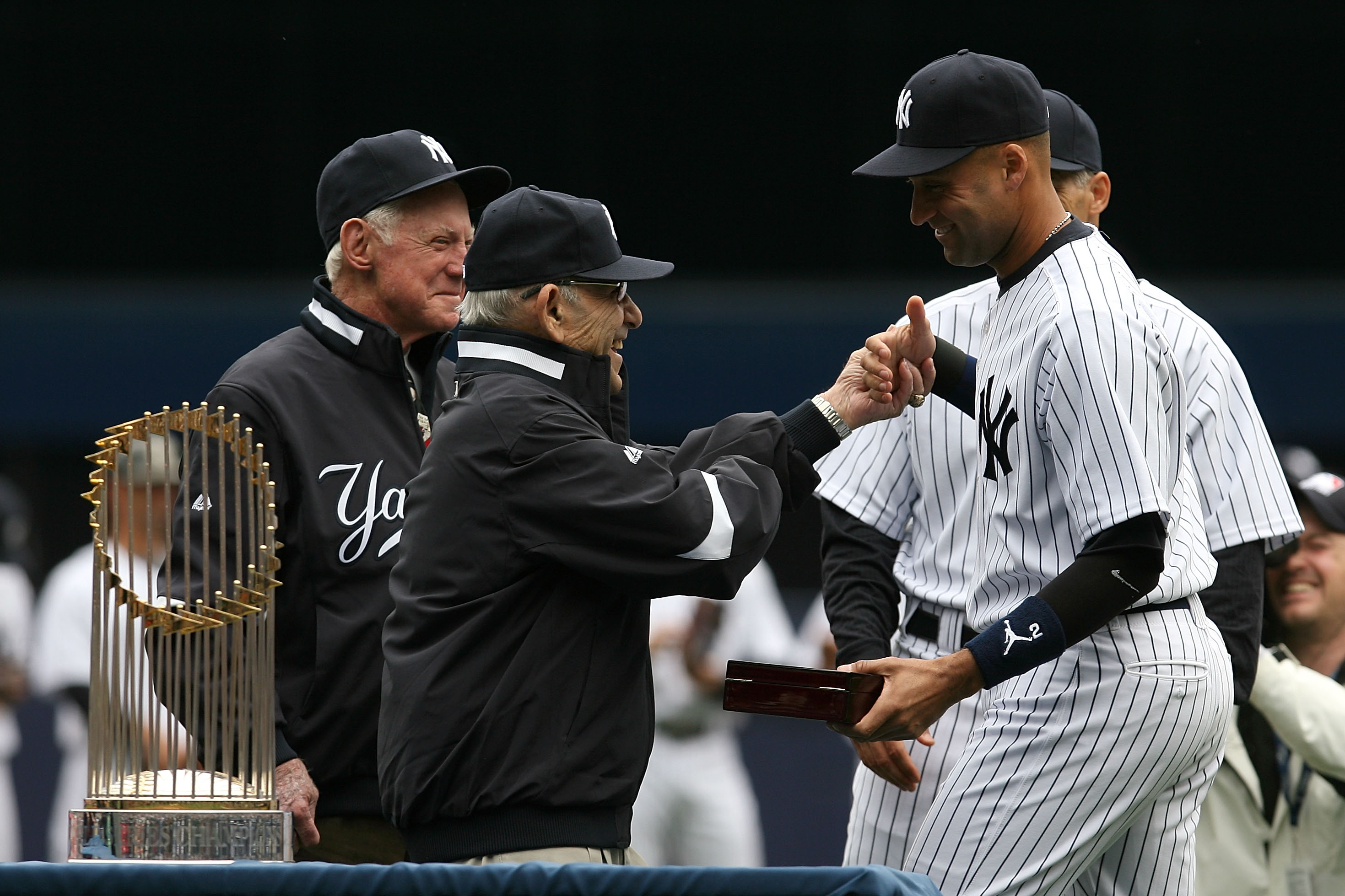 NEW YORK - APRIL 13:  Yankee legend and Baseball Hall of Famer Yogi Berra presents Derek Jeter #2 of the New York Yankees with his World Series ring for the 2009 season prior to playing against the Los Angeles Angels of Anaheim during the Yankees home ope