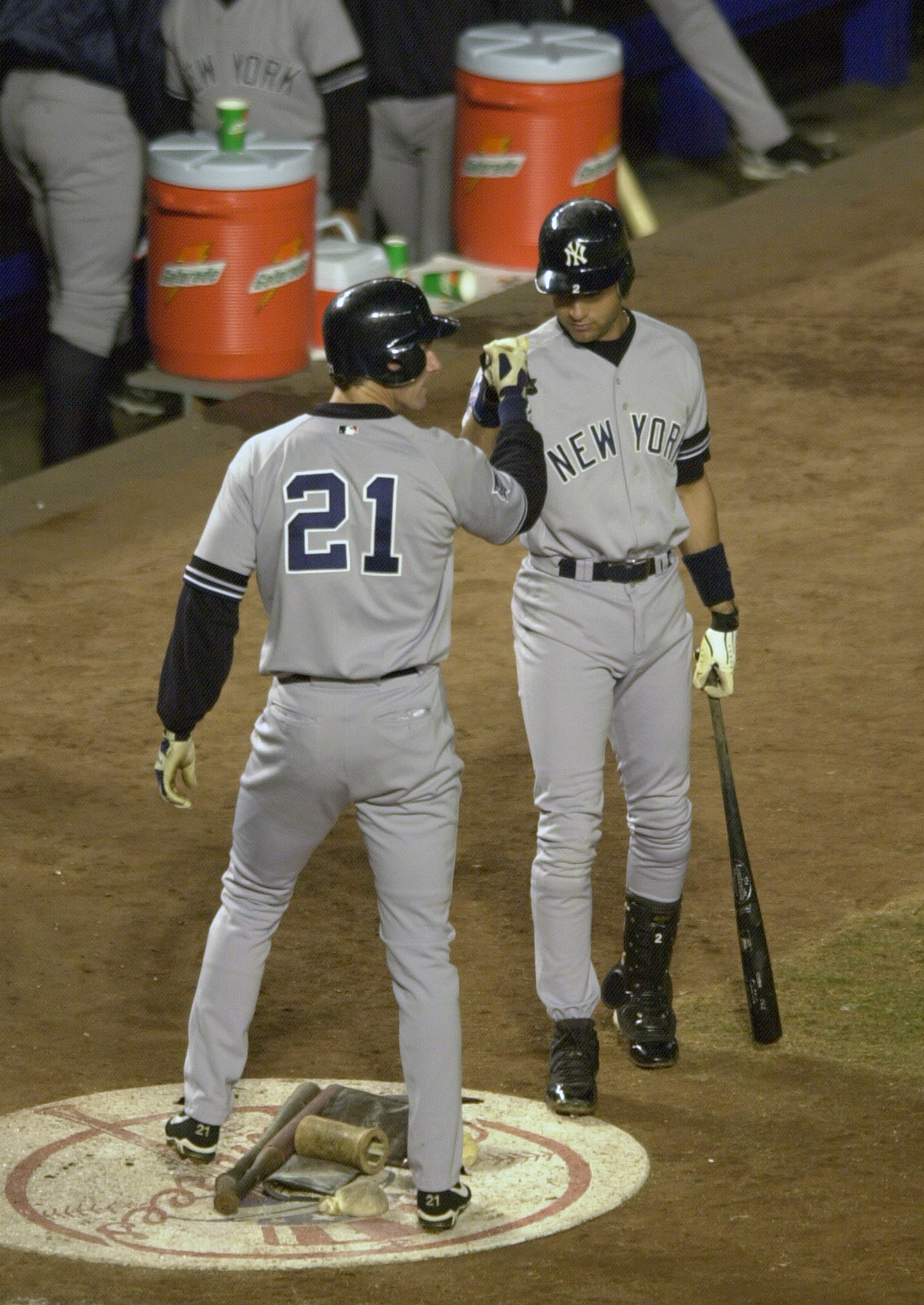 25 Oct 2000:  Outfielder Paul O''Neill #21 of the New York Yankees is congratulated by Derek Jeter #2 after scoring on a Scott Brosius sacrifice in the second inning against the New York Mets during Game 4 of the World Series at Shea Stadium in Flushing, 