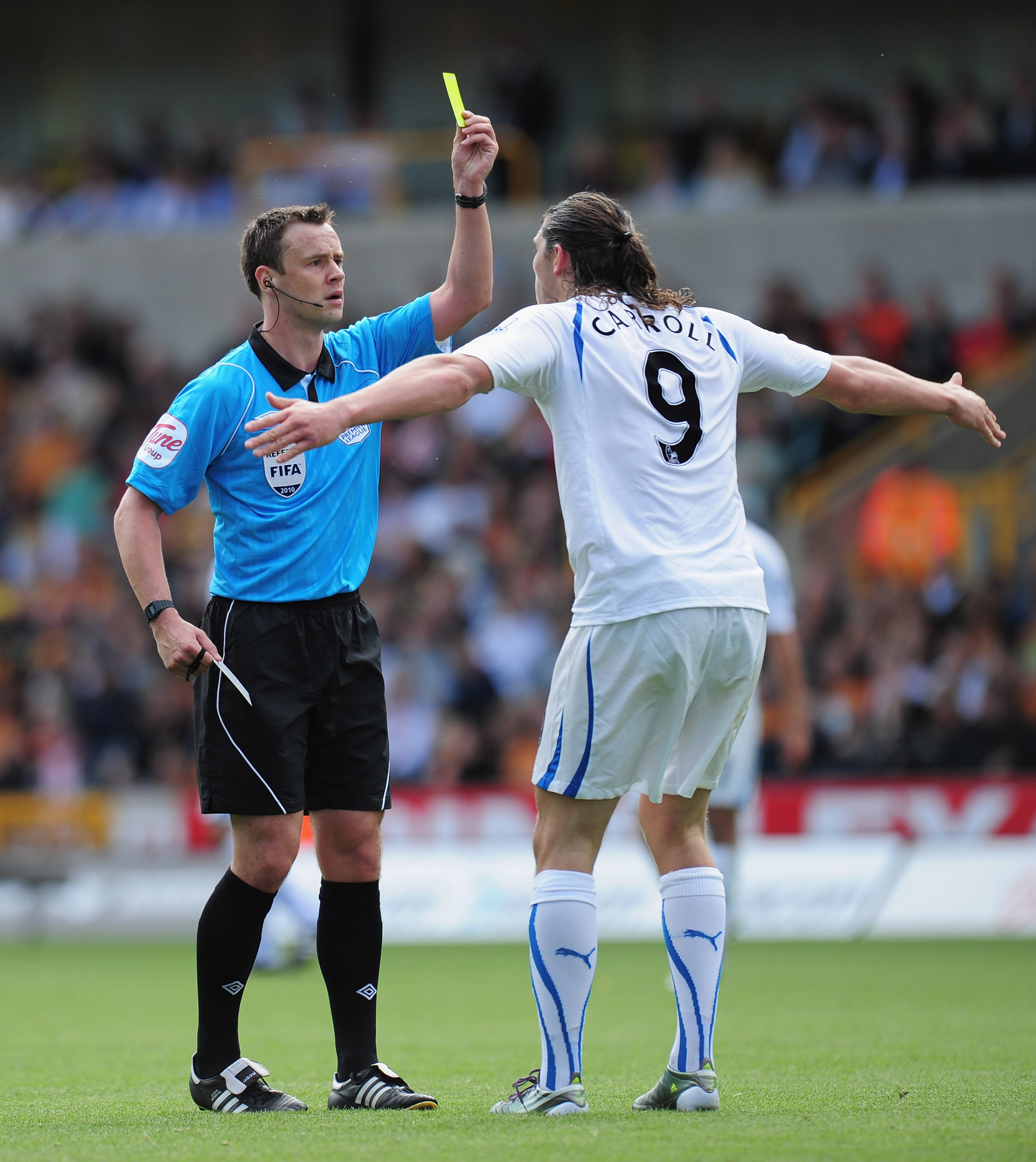 WOLVERHAMPTON, ENGLAND - AUGUST 28:  Andy Carroll of Newcastle United is booked by referee Stuart Attwell during the Barclays Premier League match between Wolverhampton Wanderers and Newcastle United at Molineux on August 28, 2010 in Wolverhampton, Englan