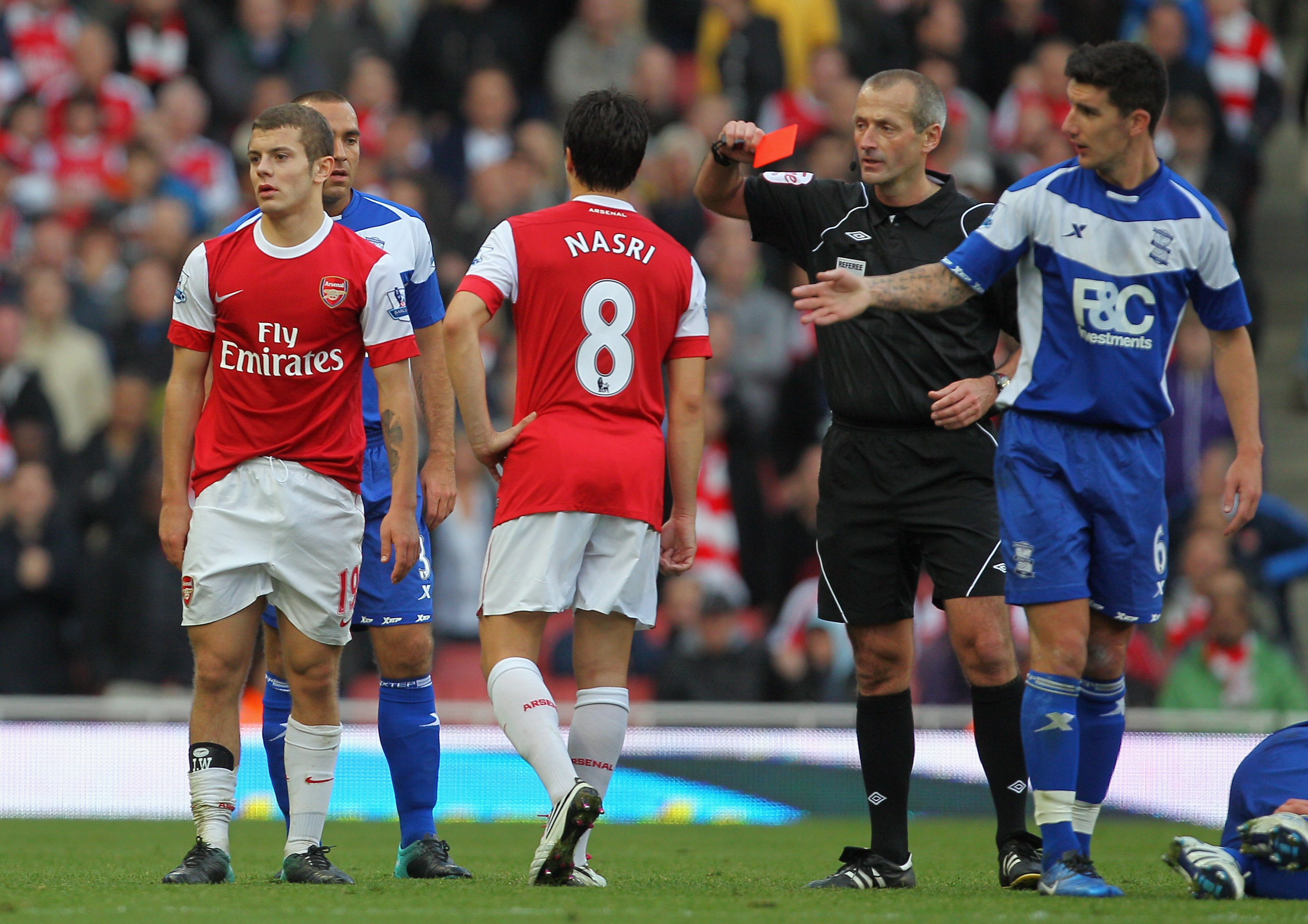 LONDON, ENGLAND - OCTOBER 16: Jack Wilshere of Arsenal is shown the red card by match referee Martin Atkinson during the Barclays Premier League match between Arsenal and Birmingham City at Emirates Stadium on October 16, 2010 in London, England.  (Photo 