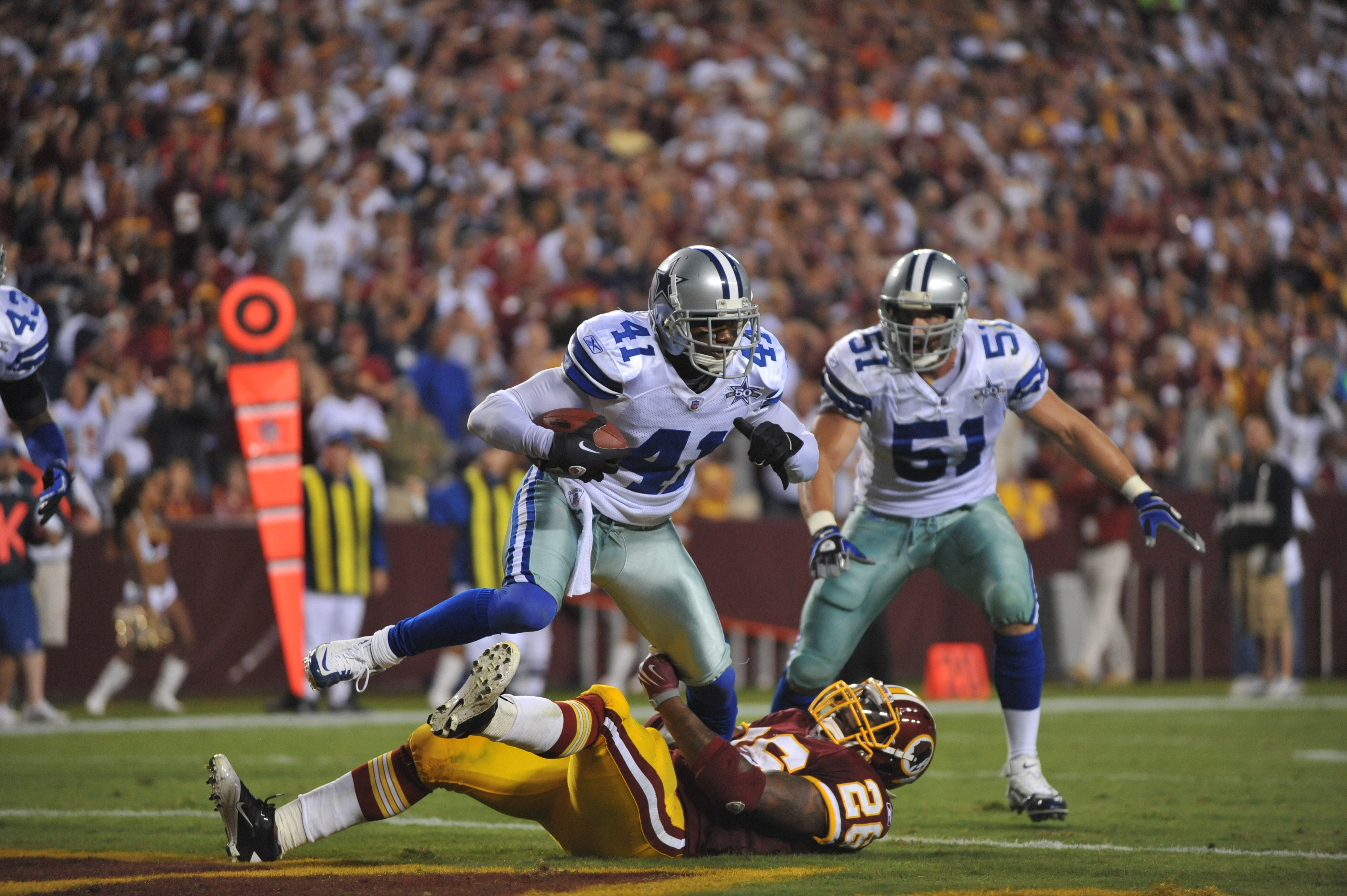 A sea of fans yells to Dallas Cowboys' Terence Newman, right, for