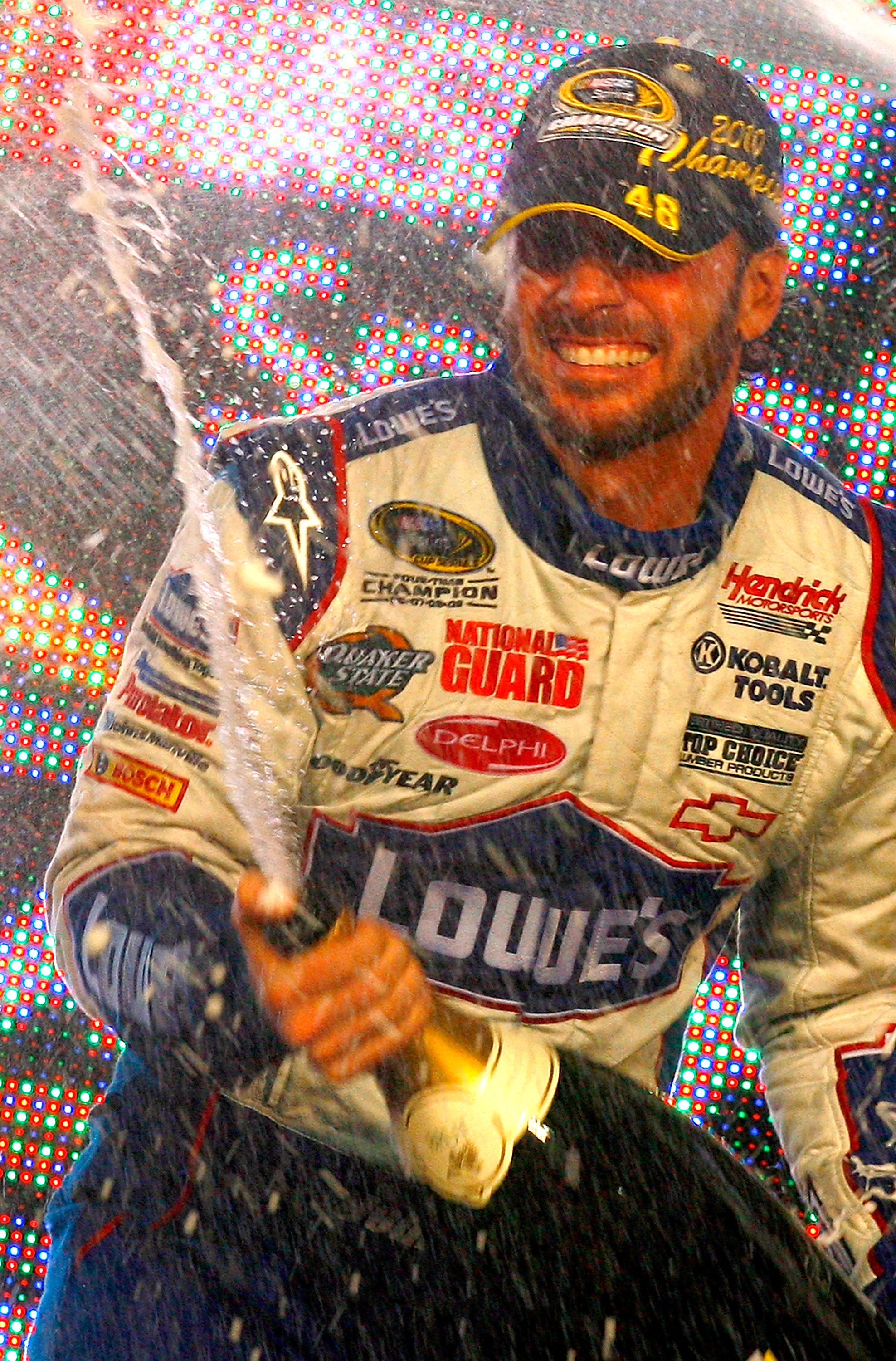 HOMESTEAD, FL - NOVEMBER 21:  Jimmie Johnson, driver of the #48 Lowe's Chevrolet, sprays champagne after winning his fifth consecutive NASCAR Sprint Cup championship following the Ford 400 at Homestead-Miami Speedway on November 21, 2010 in Homestead, Flo