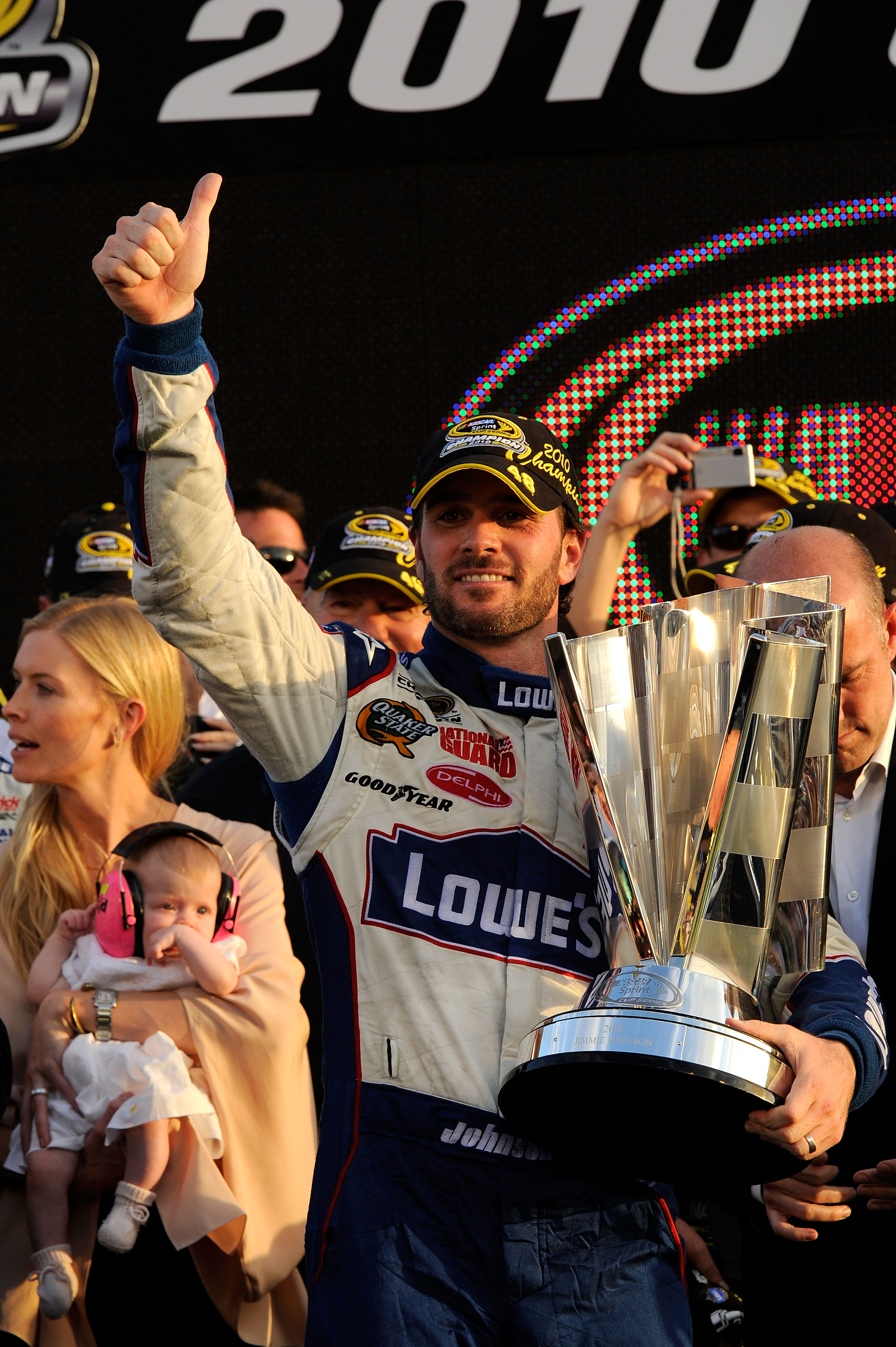 HOMESTEAD, FL - NOVEMBER 21:  Jimmie Johnson, driver of the #48 Lowe's Chevrolet, celebrates after finishing in second place in the Ford 400 to clinch his fifth consecutive NASCAR Sprint Cup championship as his wife Chandra (L) and daughter Genevieve look