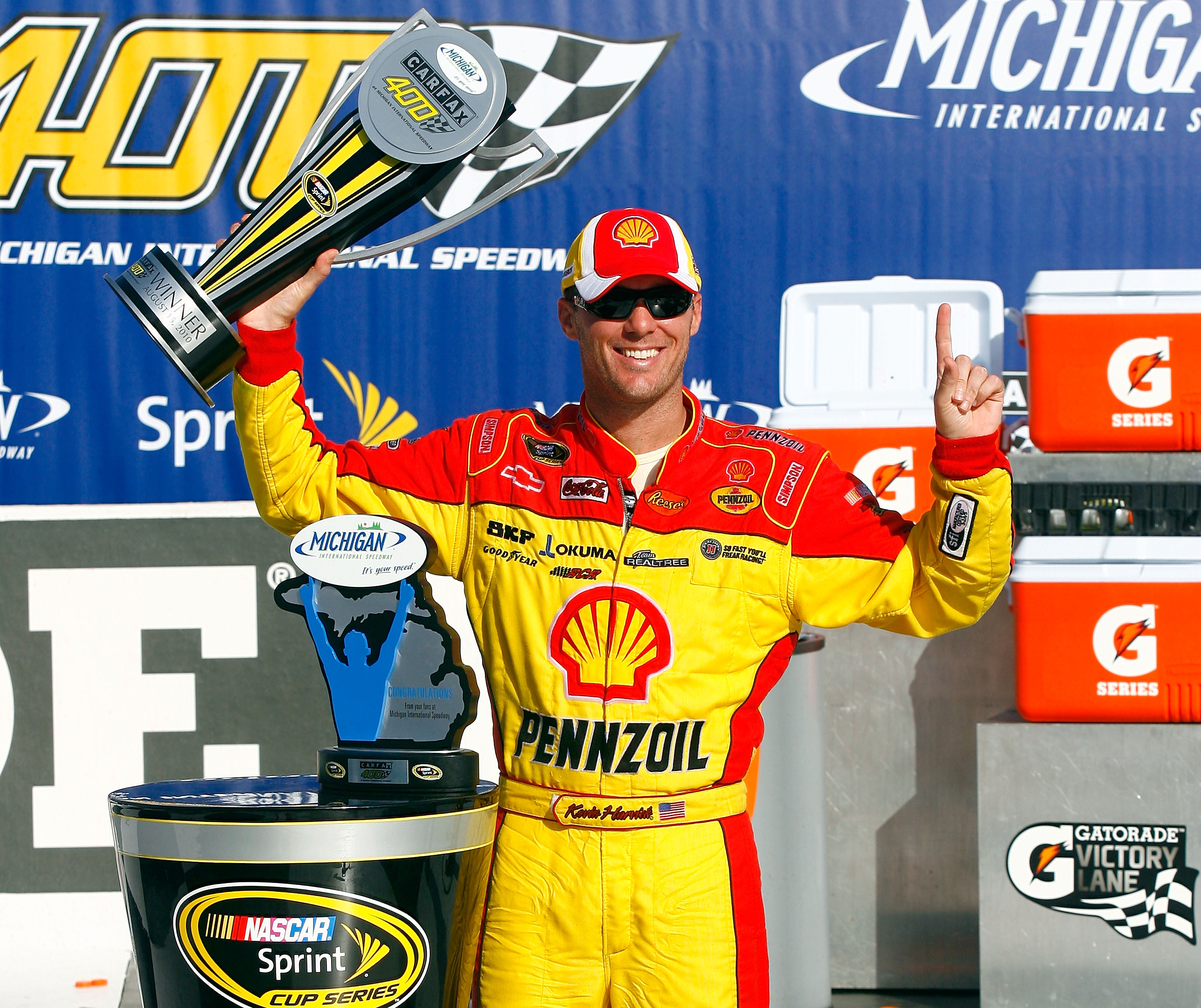 BROOKLYN, MI - AUGUST 15:  Kevin Harvick, driver of the #29 Shell/Pennzoil Chevrolet, celebrates with the trophy in victory lane after winning the NASCAR Sprint Cup Series CARFAX 400 at Michigan International Speedway on August 15, 2010 in Brooklyn, Michi