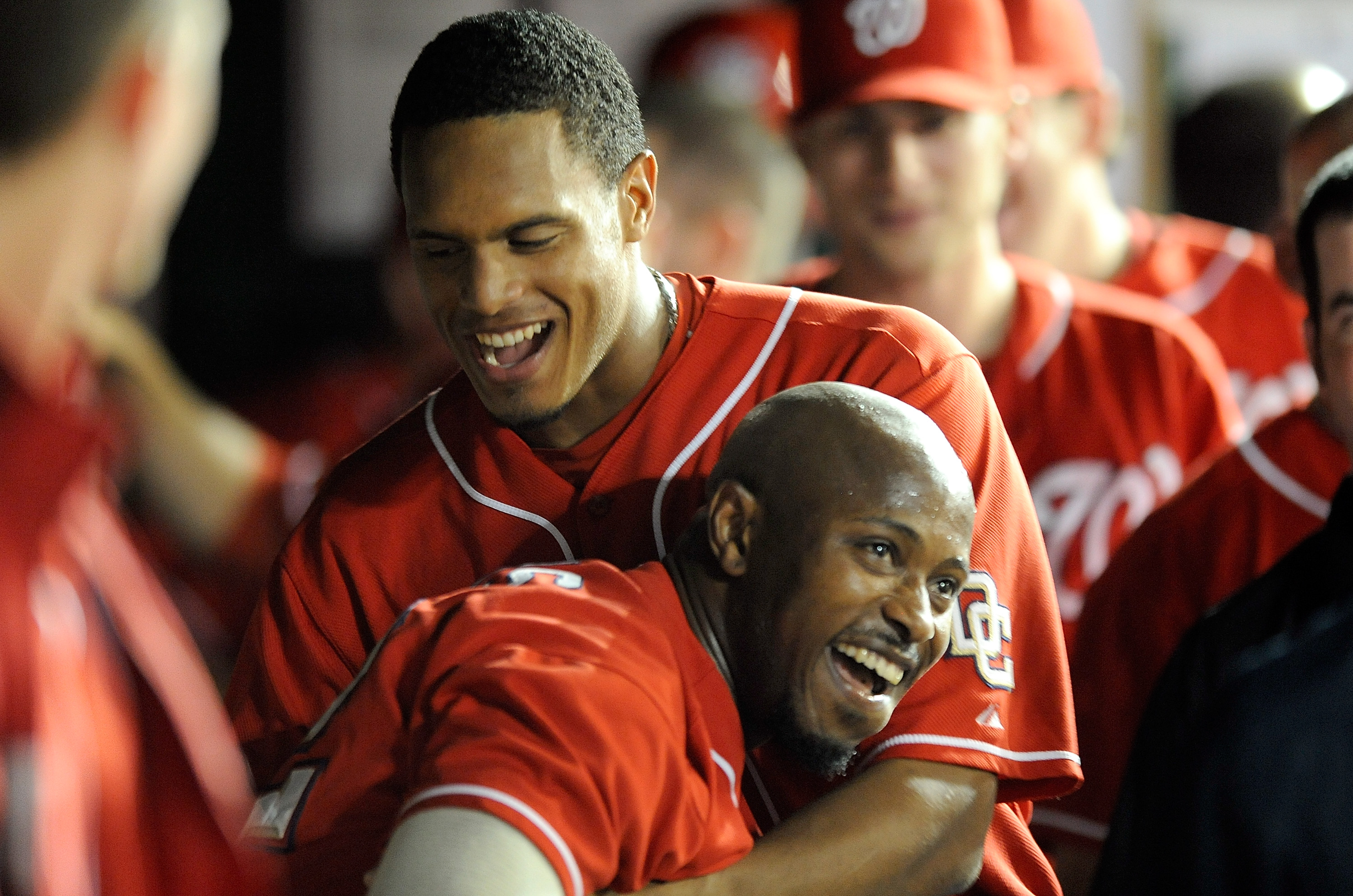 WASHINGTON - SEPTEMBER 24:  Willie Harris #22 of the Washington Nationals celebrates with Justin Maxwell #30 after hitting an inside the park home run in the seventh inning against the Atlanta Braves at Nationals Park on September 24, 2010 in Washington,