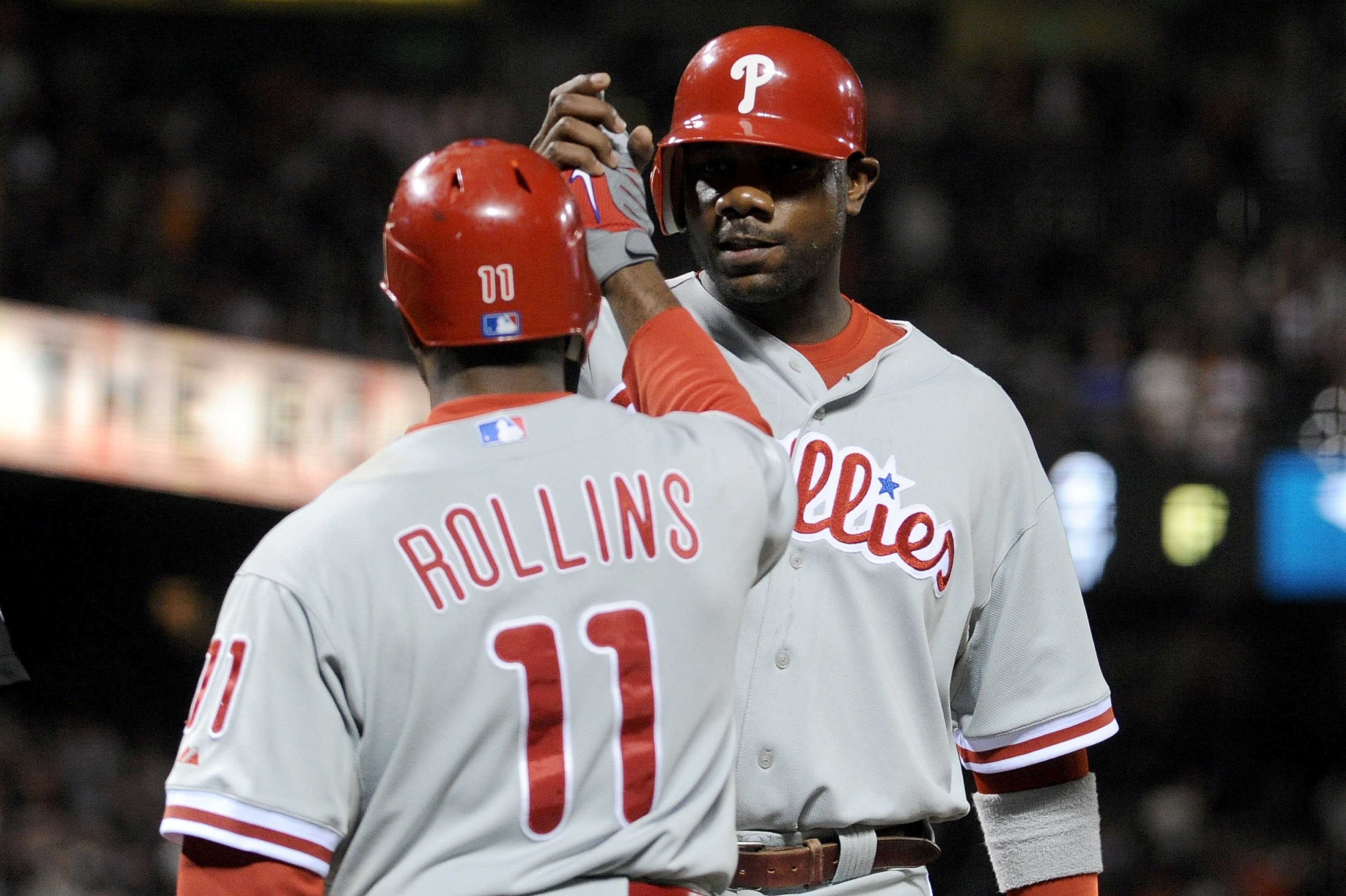 SAN FRANCISCO - OCTOBER 20:  Ryan Howard #6 of the Philadelphia Phillies celebrates with Jimmy Rollins #11 after scoring in the eighth inning against the San Francisco Giants in Game Four of the NLCS during the 2010 MLB Playoffs at AT&T Park on October 20