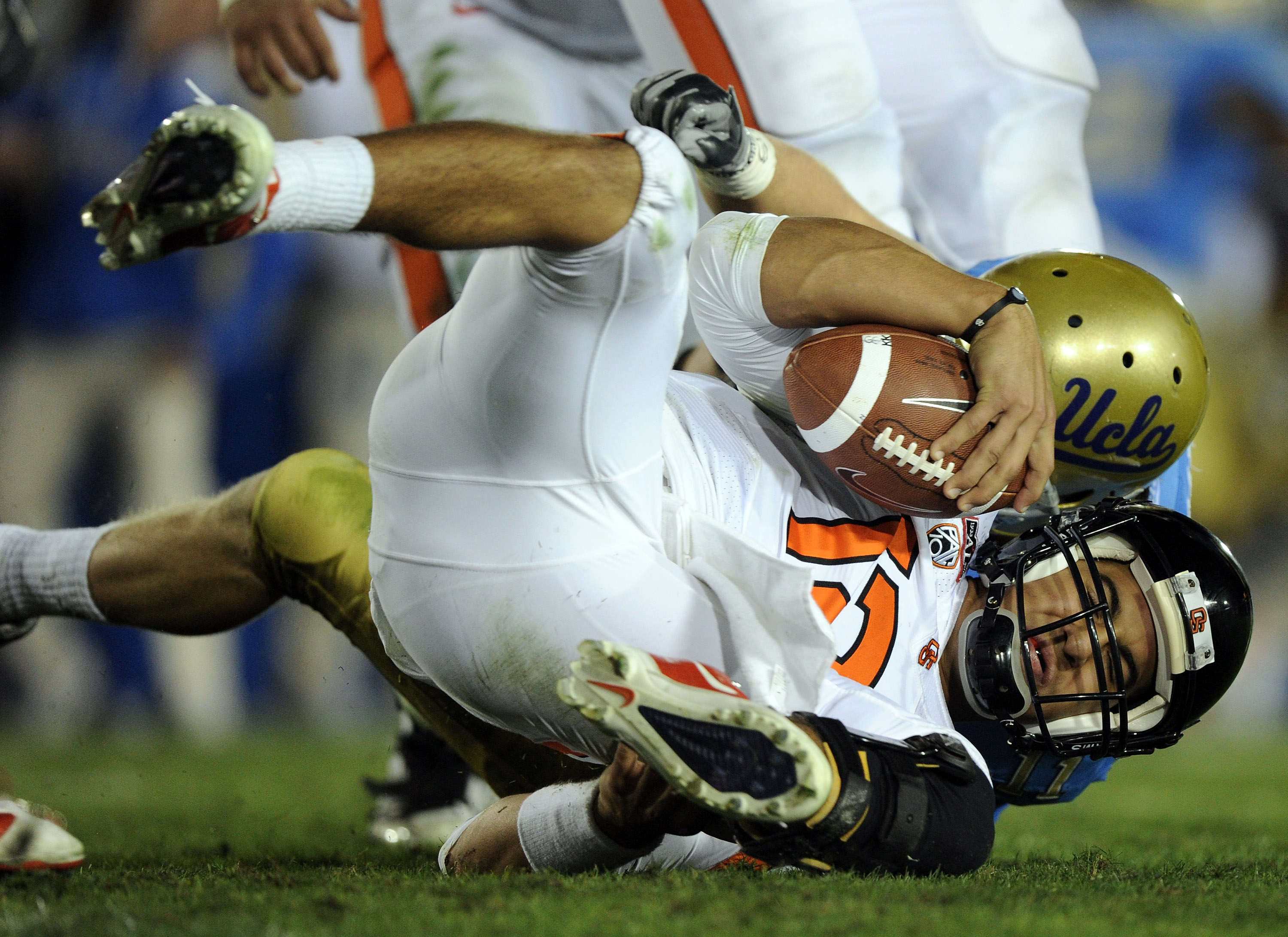 PASADENA, CA - NOVEMBER 06: Ryan Katz #12 of the Oregon State Beavers is sacked by Sean Westgate #11 of the UCLA Bruins during the fourth quarter at the Rose Bowl on November 6, 2010 in Pasadena, California. (Photo by Harry How/Getty Images)