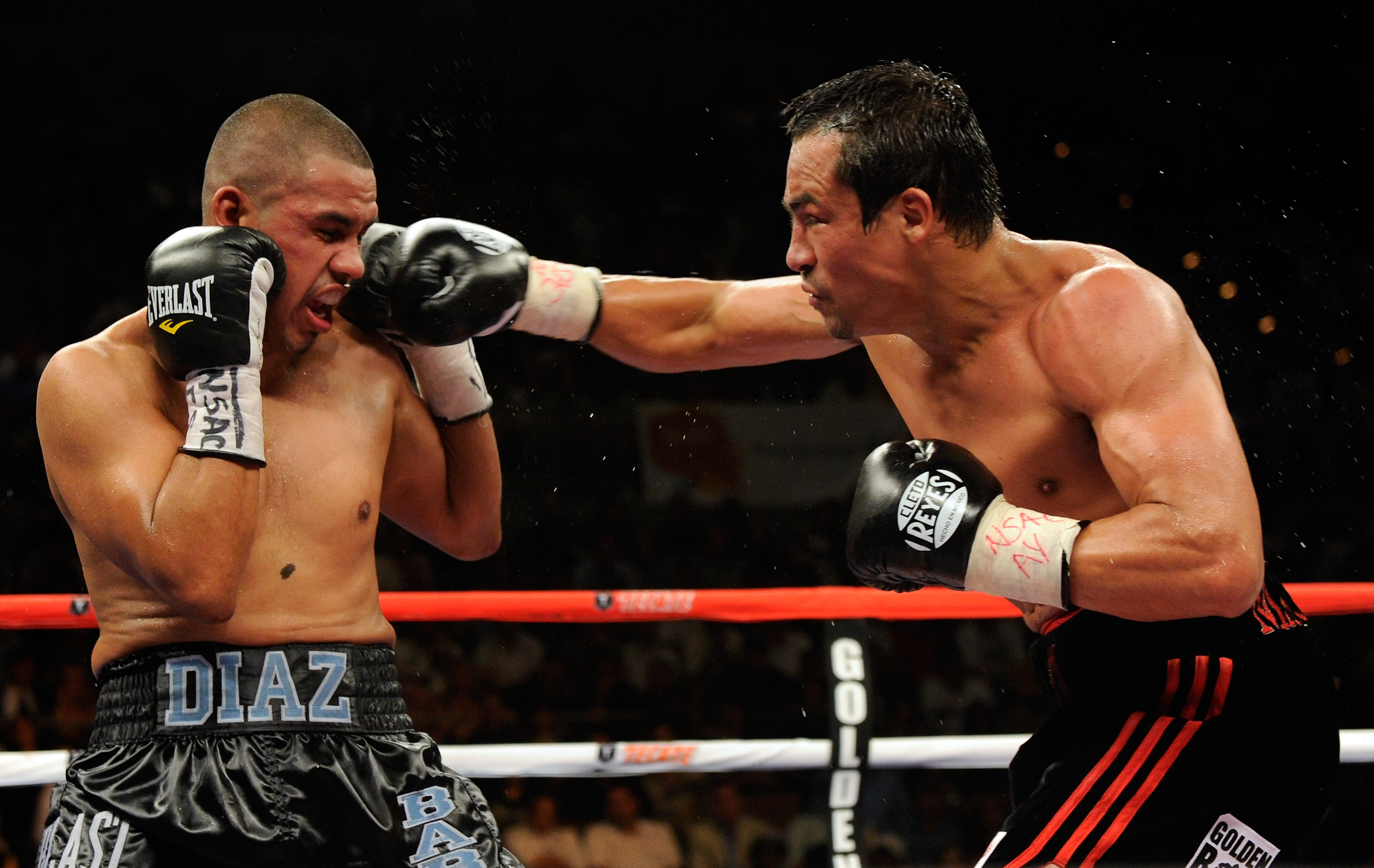 LAS VEGAS - JULY 31:  WBA/WBO lightweight champion Juan Manuel Marquez (R) hits Juan Diaz in the eighth round of their bout at the Mandalay Bay Events Center July 31, 2010 in Las Vegas, Nevada. Marquez retained his WBA and WBO lightweight championship bel
