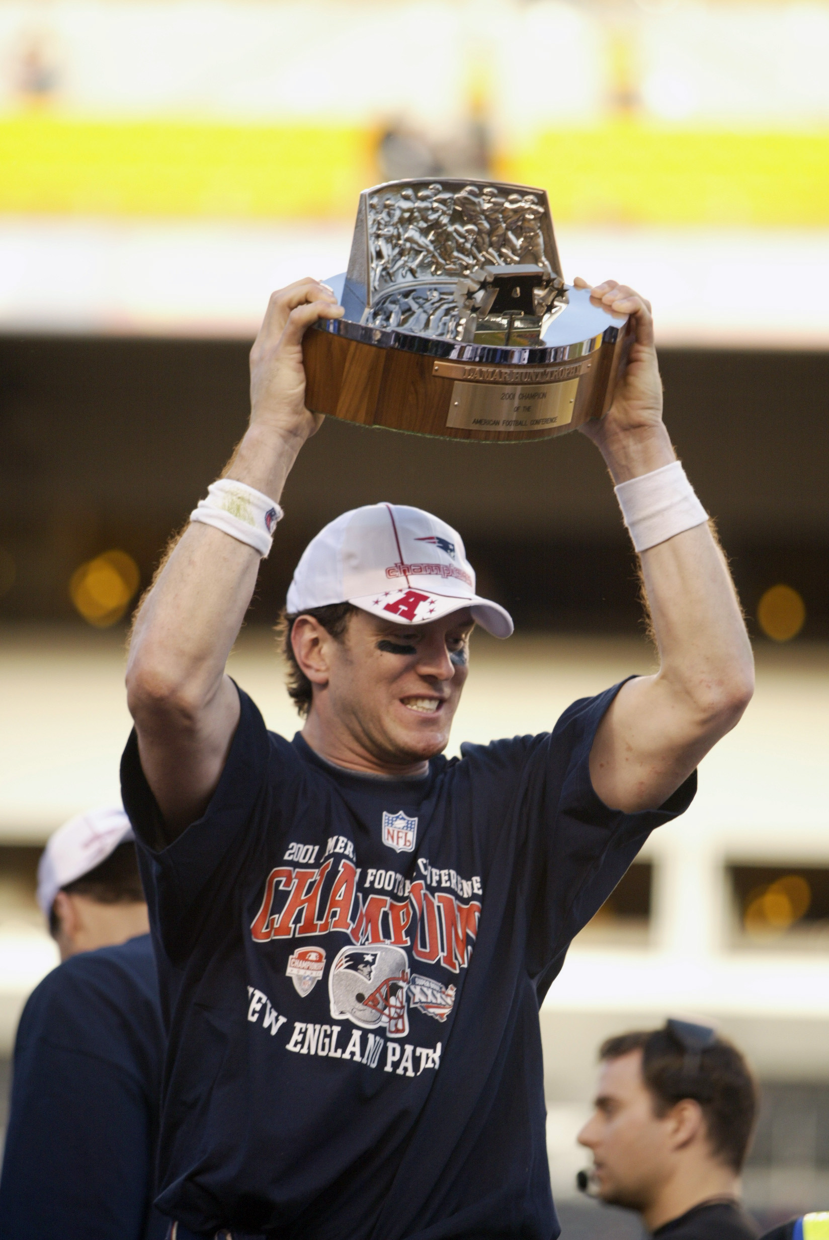 27 Jan 2002: Quarterback Drew Bledsoe of the New England Patriots presents the championship trophy after the AFC Championship Game against the Pittsburgh Steelers at Heinz Field in Pittsburgh, Pennsylvania. The Patriots won 24-17. DIGITAL IMAGE. Mandatory