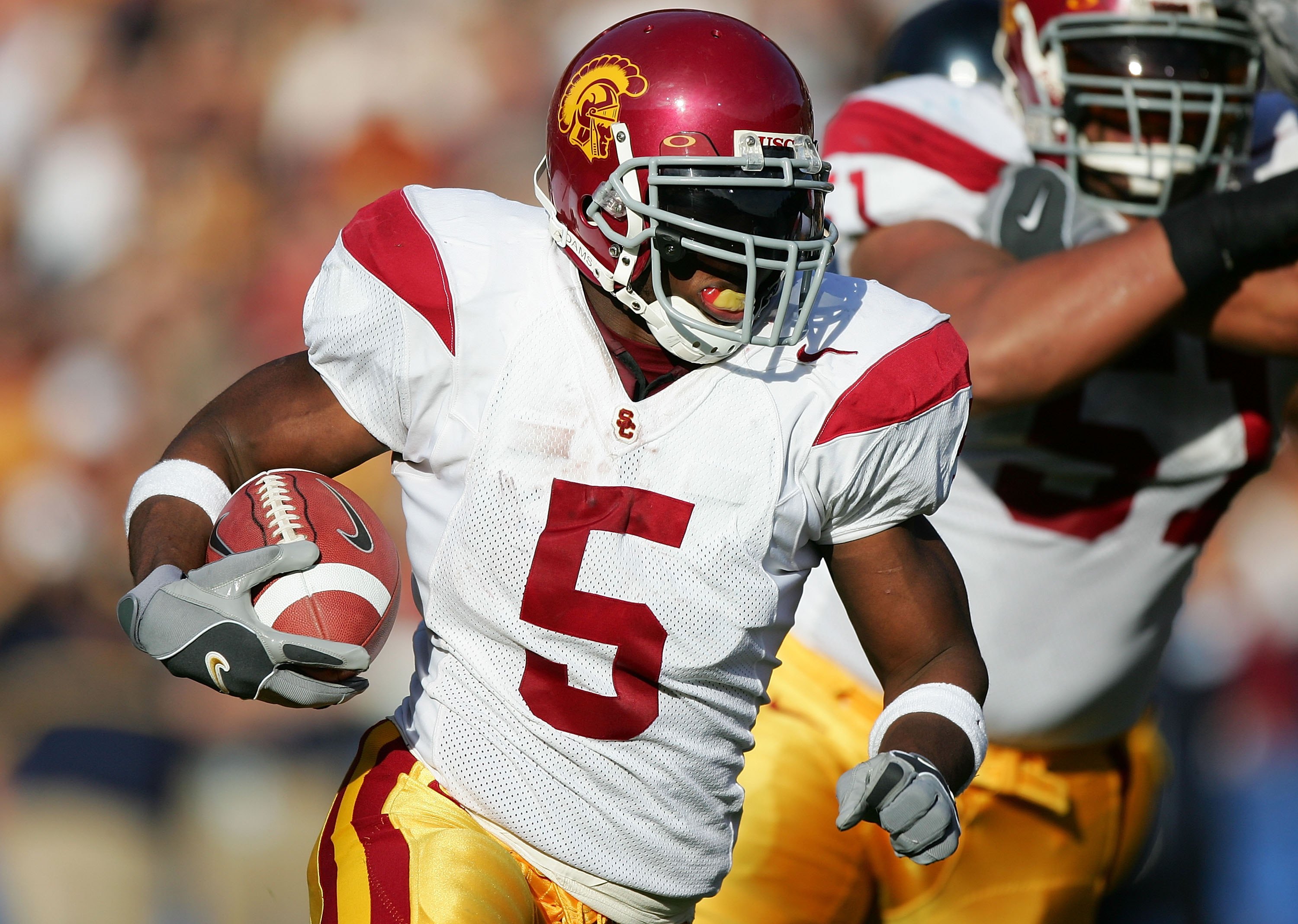 BERKELEY, CA - NOVEMBER 12:  (FILE PHOTO) Reggie Bush #5 of the USC Trojans runs with the ball against the California Golden Bears at Memorial Stadium on November 12th, 2005 in Berkeley, California. Bush was picked second overall by the New Orleans Saints