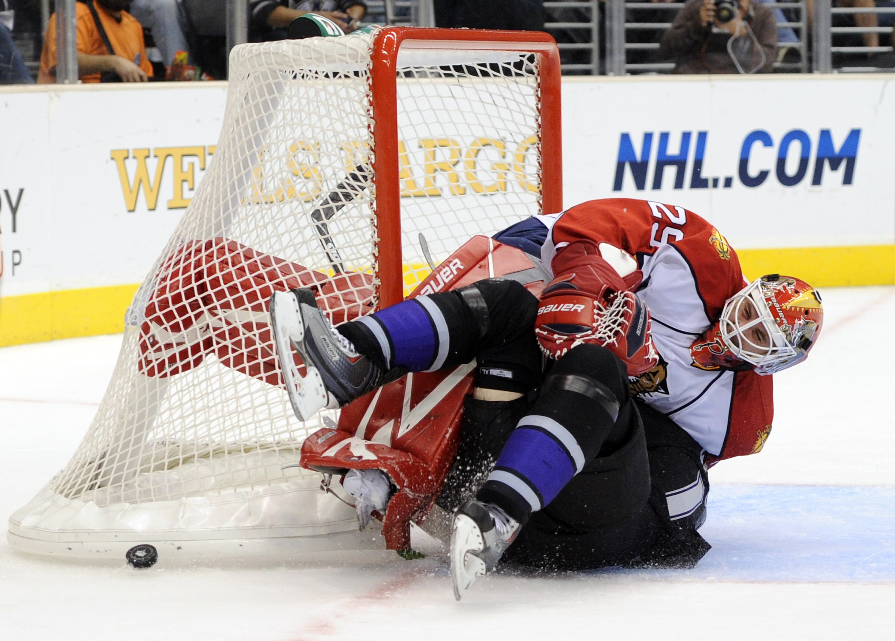 LOS ANGELES, CA - DECEMBER 02:  Tomas Vokoun #29 of the Florida Panthers is knocked to the ice by a fallen Justin Williams #14 of the Los Angeles Kings during the second period on December 2, 2010 in Los Angeles, California.  (Photo by Harry How/Getty Ima