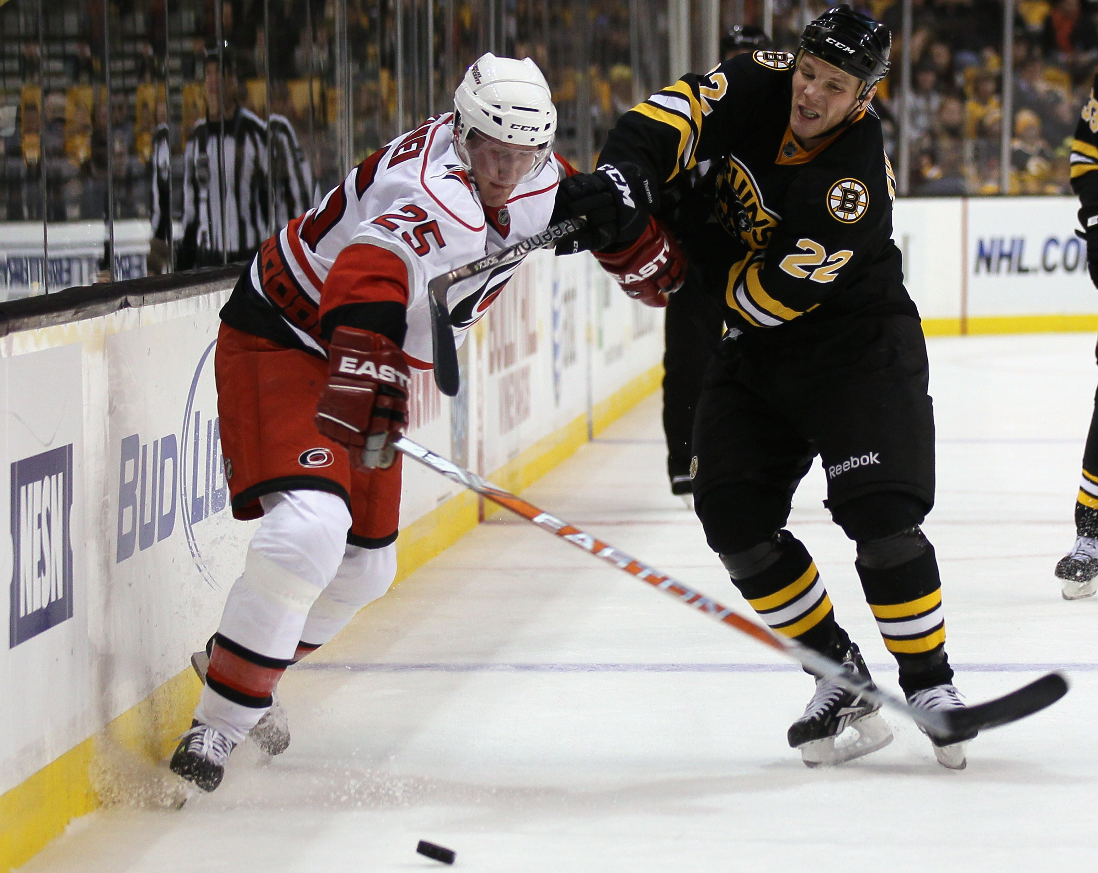 BOSTON - NOVEMBER 26:  Shawn Thornton #22 of the Boston Bruins and Joni Pitkanen #25 of the Carolina Hurricanes fight for the puck on November 26, 2010 at the TD Garden in Boston, Massachusetts. The Hurricanes defeated the Bruins 3-0.  (Photo by Elsa/Gett