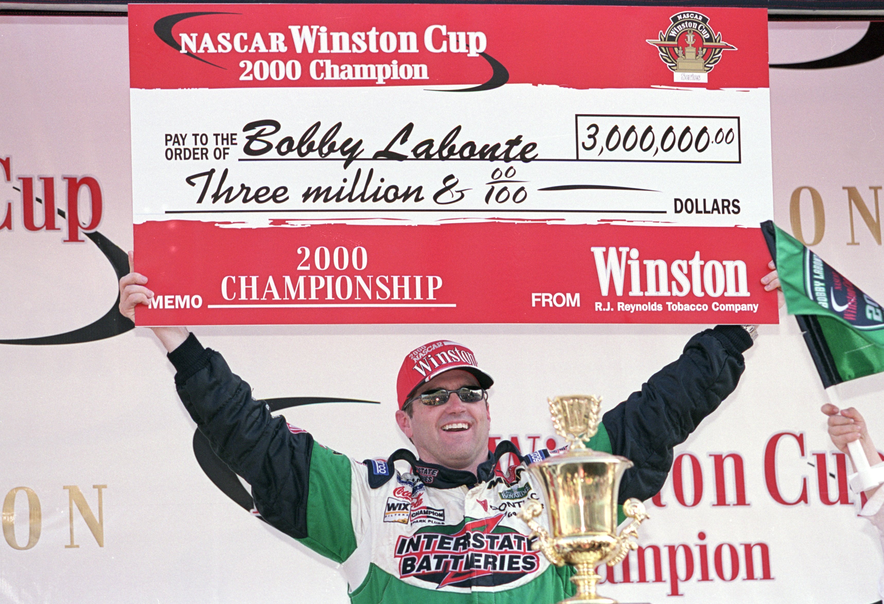 12 Nov 2000:   Driver Bobby Labonte #18 who drives a Pontiac Grand Prix for Joe Gibbs Racing holds up the winners check after the Pennzoil 400, part of the NASCAR Winston Cup Series at the Homestead Miami Speedway in Homestead, Florida.Mandatory Credit: D